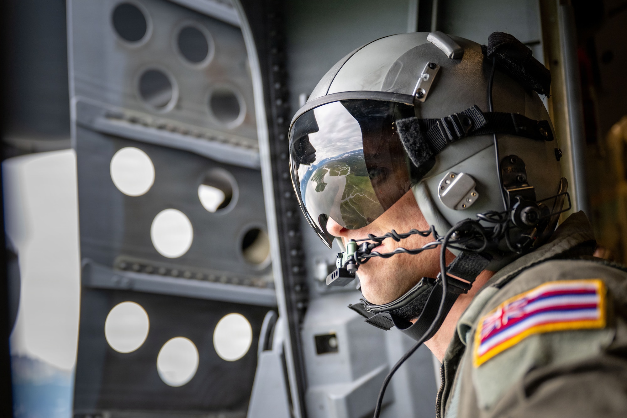 Hawaii Air National Guard Staff Sgt. Alex Blankenship, 204th Airlift Squadron loadmaster, looks
out the door of a C-17 Globemaster III before a static line air drop over Joint Base Elmendorf-
Richardson, July 17, 2026. Arctic Predictable Iron ’26 tested the participating units’ ability to deploy airborne forces across Alaska’s complex terrain rapidly. (U.S. Air Force photo by Senior
Airman Lauren Torres)