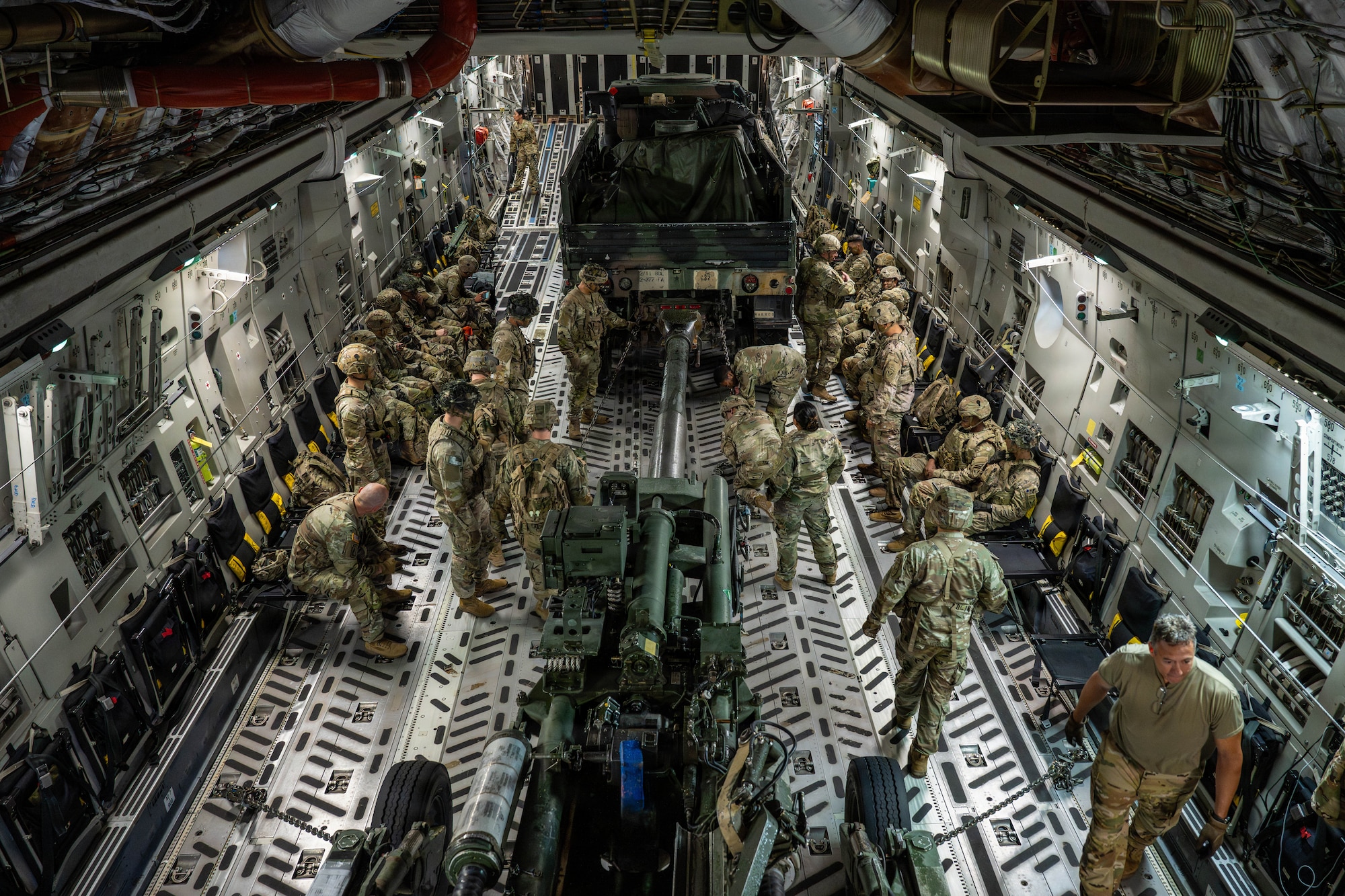 U.S. Airmen and Soldiers tie down a M777A2 medium towed howitzer inside a C-17
Globemaster III at Joint Base Elmendorf-Richardson, Alaska, July 13, 2026. The howitzer was
loaded onto the aircraft in preparation for a semi-prepared runway operation with the 2nd
Battalion, 377th Parachute Field Artillery Regiment, 11th Airborne Division. (U.S. Air Force
photo by Senior Airman Lauren Torres)