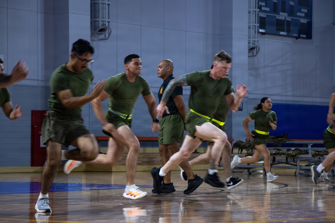 .S. Marines attending the Marine Corps Air Station Iwakuni Sergeants Course perform dynamic warmups at MCAS Iwakuni, July 15, 2026. The inaugural resident sergeants course expanded professional military education opportunities for Marines stationed in Japan. (U.S. Marine Corps photo by Cpl. Alejandra Vega)