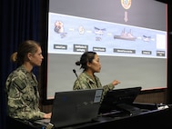 SAN DIEGO (May 14, 2026) — Lt. Cmdr. Kristine Tolentino Parra, right, and Lt. Stephanie Ryan, left, provide an overview of the historic Artemis II recovery mission during a presentation at the Naval Medical Forces Pacific headquarters.  Parra, a general surgeon and platform lead for Expeditionary Resuscitative Surgical System 14 at Navy Medicine Readiness and Training Command Camp Pendleton, and Ryan, a Navy nurse with En Route Care System 11 at NMRTC San Diego, served with their teams that stood ready to provide medical support to the astronauts and the Navy recovery team during the operations. (U.S. Navy photo by Arsenio R. Cortez Jr.)
