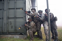 Soldiers from Guam Army National Guard and the Malaysian Army’s 5th Infantry Division take cover behind a building during a force on force exercise during Keris Strike 26 near Kota Belud, Malaysia, July 22, 2026.