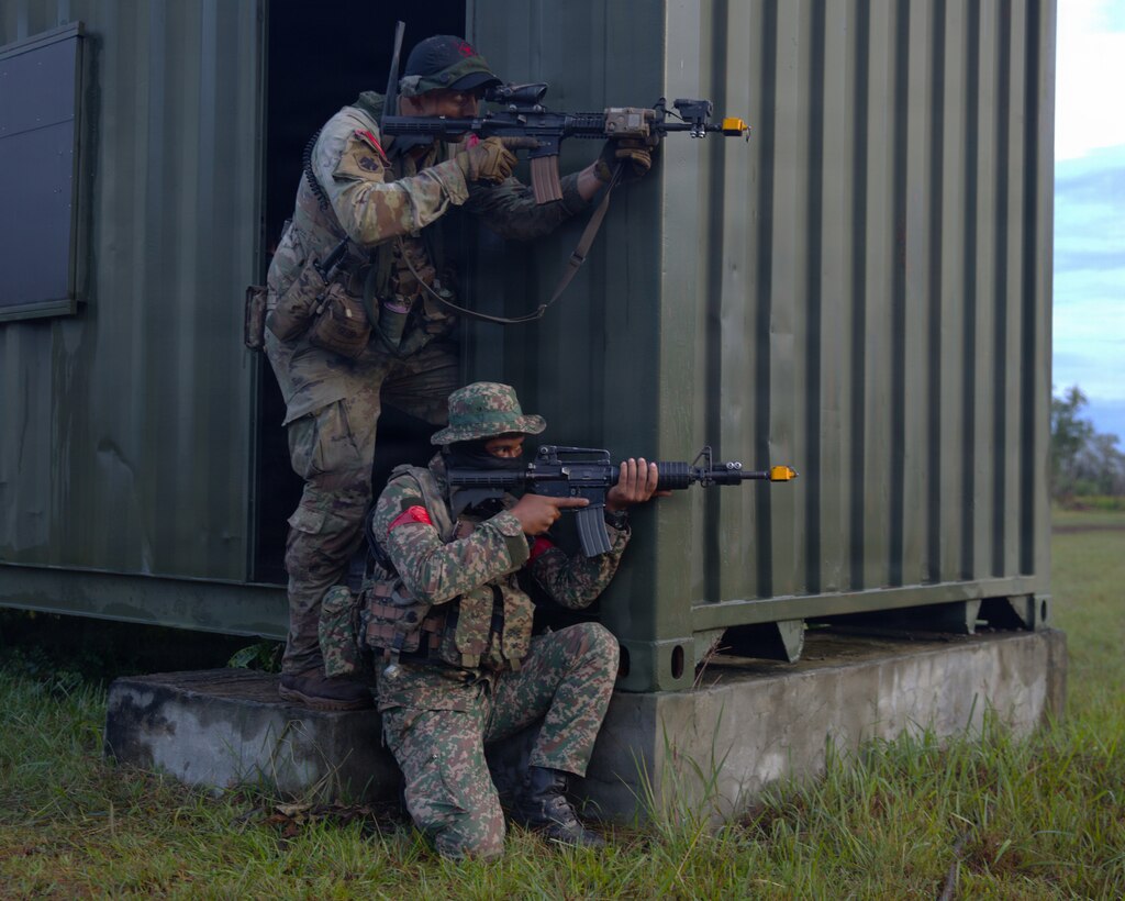 A Soldier from the Oklahoma Army National Guard and the Malaysian Army’s 5th Infantry Division take aim at enemy positions during a force-on-force exercise during Keris Strike 26 near Kota Belud, Malaysia, July 22, 2026.