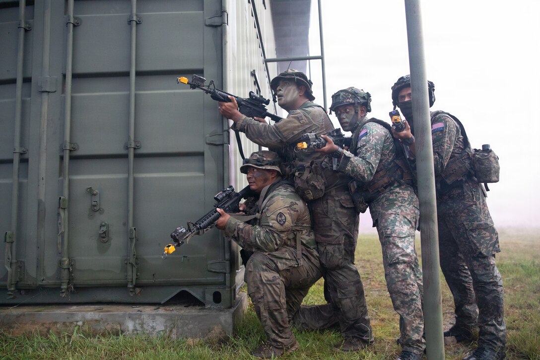 Soldiers from Guam Army National Guard and the Malaysian Army’s 5th Infantry Division take cover behind a building during a force on force exercise during Keris Strike 26 near Kota Belud, Malaysia, July 22, 2026.