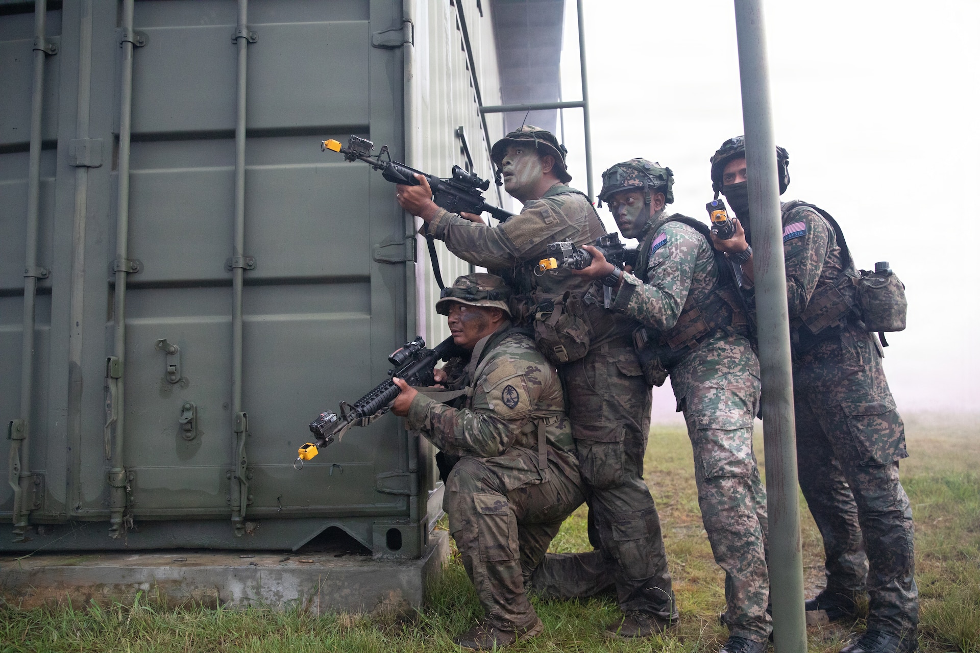 Soldiers from Guam Army National Guard and the Malaysian Army’s 5th Infantry Division take cover behind a building during a force on force exercise during Keris Strike 26 near Kota Belud, Malaysia, July 22, 2026.