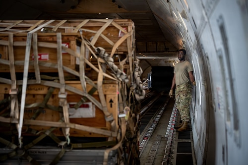 U.S. Air Force Airman 1st Class Kolade Fasesin, 35th Munitions Squadron ammo stockpile specialist, manages a control panel for cargo loading onto a Boeing 747 transport aircraft in support of Red Flag-Alaska 26-3.