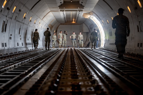 U.S. Airmen assigned to the 35th Mission Support Group prepare to load cargo onto a Boeing 747 transport aircraft in support of Red Flag-Alaska 26-3.