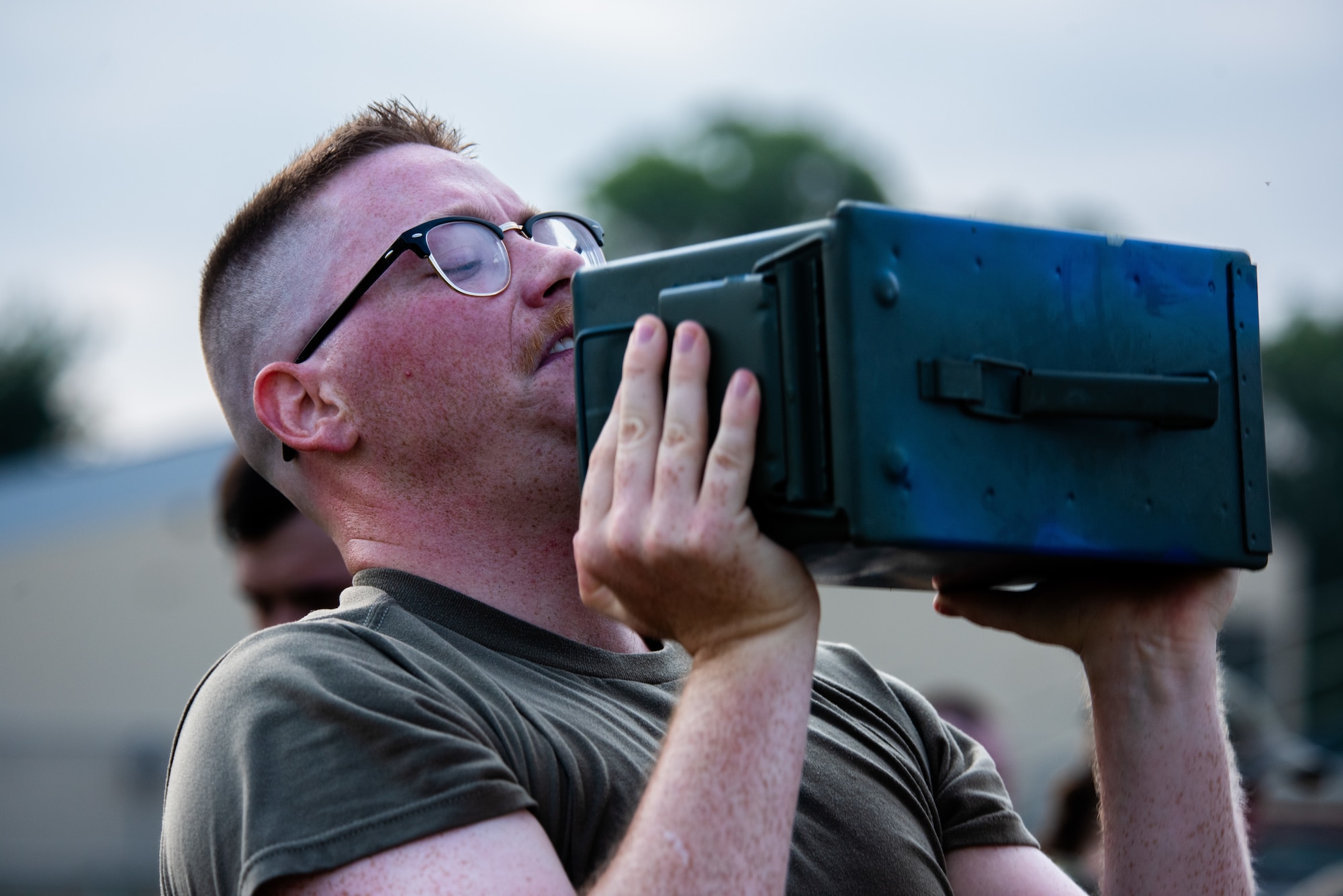 U.S. Air Force Senior Airman Jacob O’Grady, an Airman Leadership School student, lifts an ammunition can.