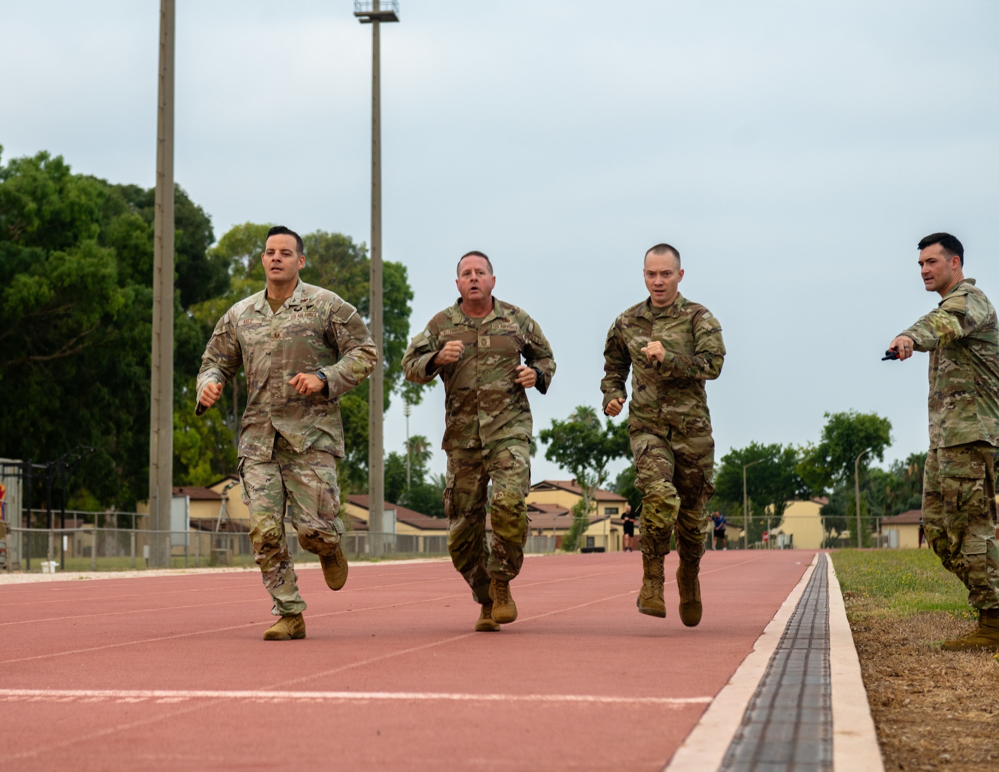 U.S. Air Force Master Sgt. Matthew Katz, 39th Air Base Wing aviation safety superintendent, and Chief Master Sgt. Sean Ellenburg, 39th ABW command chief, run alongside Airman Leadership School students.