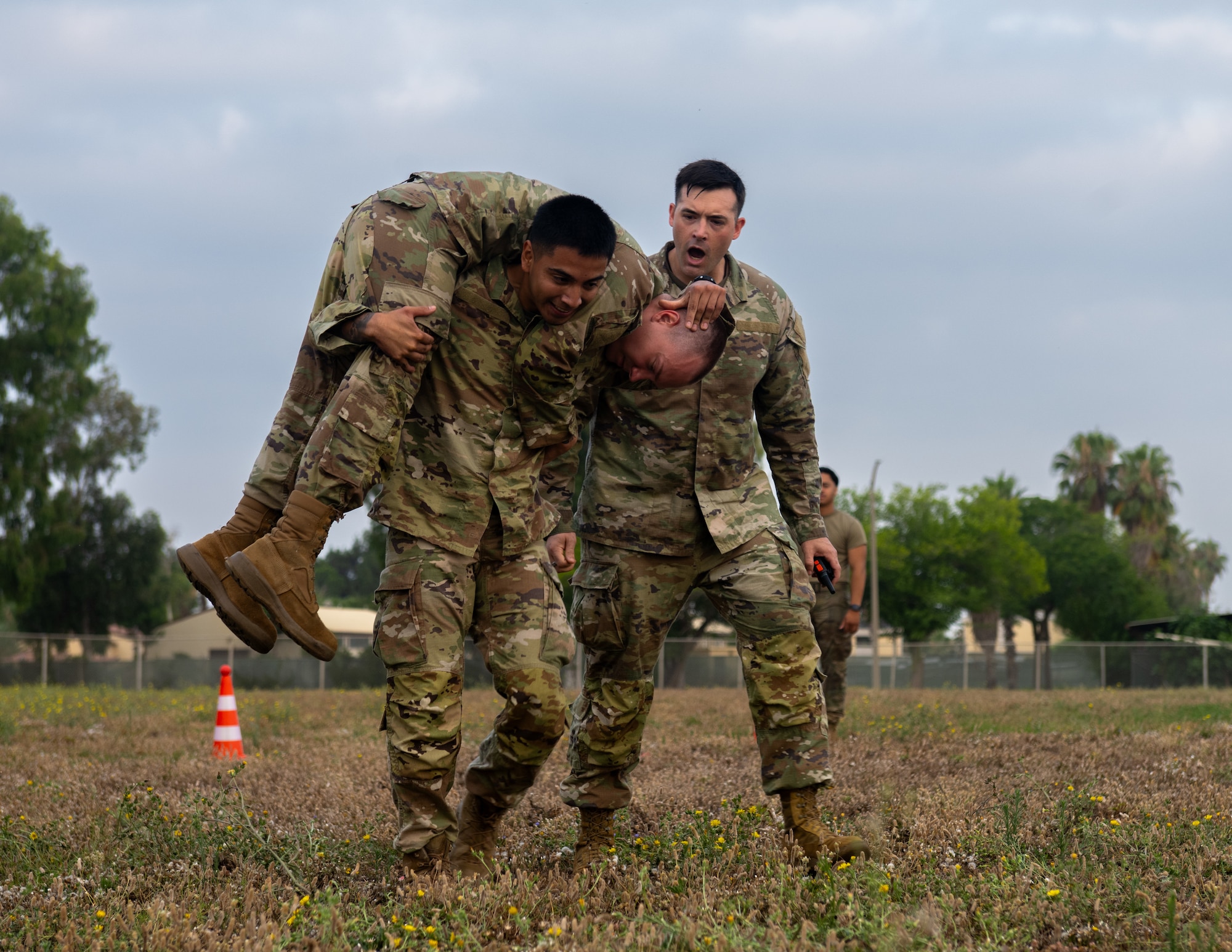 U.S. Air Force Tech. Sgt. Chance Stone, right, 39th Force Support Squadron Airman Leadership School instructor, motivates Senior Airman Kevin Cruz, an ALS student, as he completes a teammate carry.