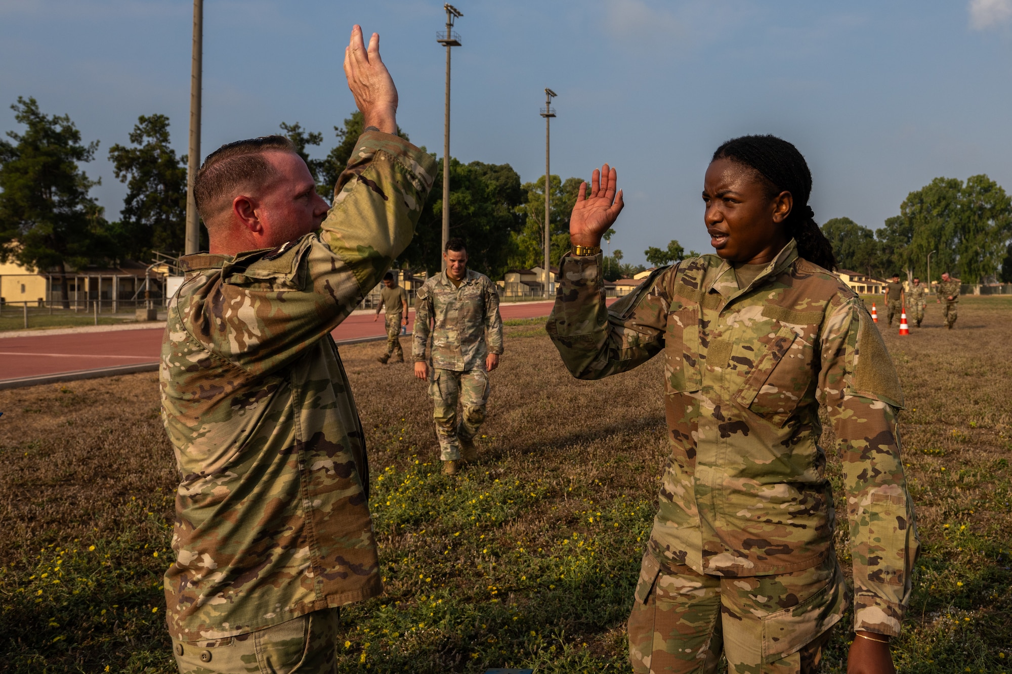 U.S. Air Force Chief Master Sgt. Sean Ellenburg, 39th Air Base Wing command chief, congratulates Senior Airman Rashkaina Mertilien, an Airman Leadership School student.