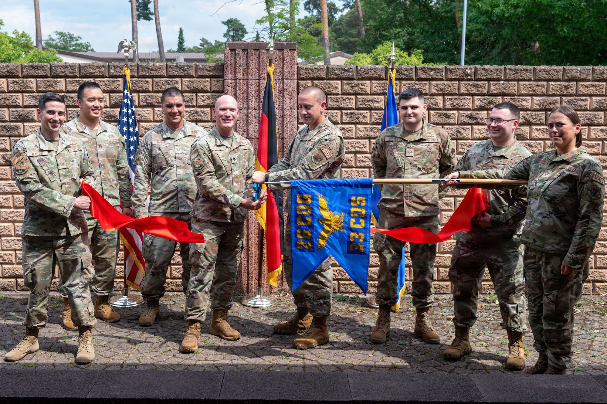 U.S. Air Force Lt. Col. Kenneth Sturgis, 33d Cyberspace Operations Squadron commander, and Chief Master Sgt. Philip Ballenger, 33d COS senior enlisted leader, cut a ribbon during the 33d COS Operating Location Echo opening ceremony.