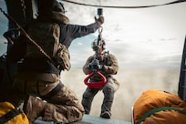 U.S. Air Force Master Sgt. Allenmikel Armstrong, 212th Rescue Squadron pararescueman, hoists from a HH-60W Jolly Green II during the Arctic Thunder Open House 26 full-scale exercise on Joint Base Elmendorf-Richardson, Alaska, June 17, 2026.