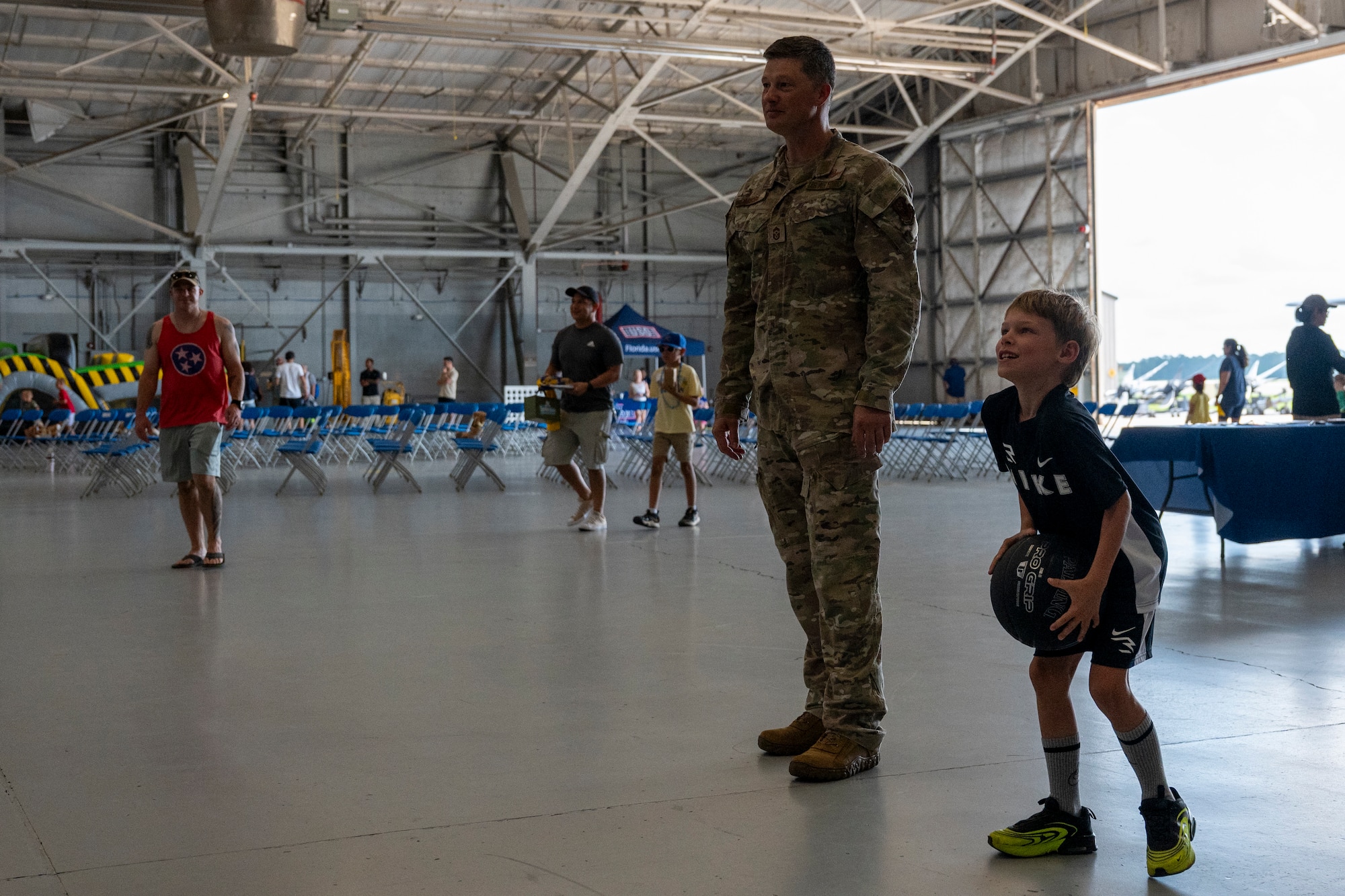 Chief Master Sgt. Joshua Moore, 1st Special Operations Wing command chief, plays basketball with a military child during an Operation Discovering and Exploring Military Operations homecoming event at Hurlburt Field, Florida, June 27, 2026.