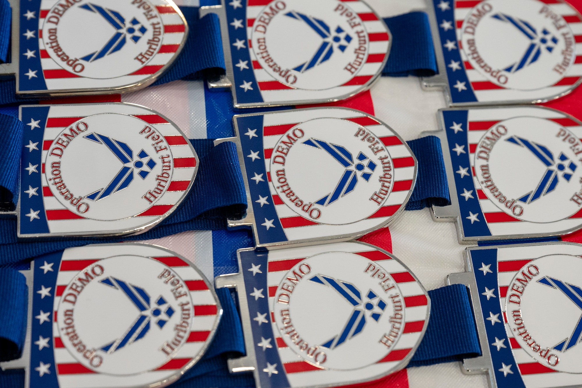 Medals are displayed on a table before a simulated deployment ceremony during an Operation Discovering and Exploring Military Operations homecoming event at Hurlburt Field, Florida, June 27, 2026.
