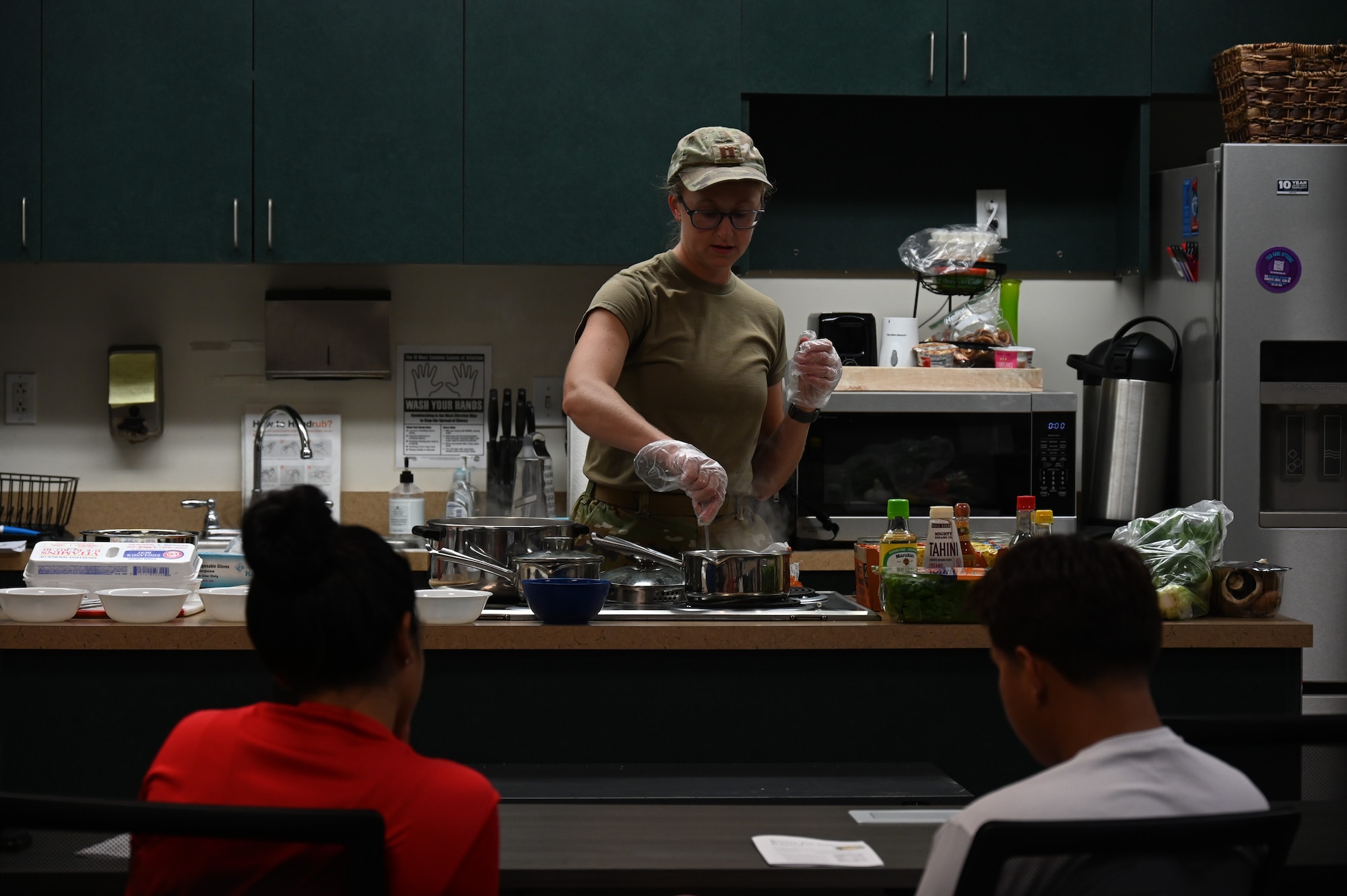 U.S. Air Force Capt. Rebekah Suggs, Laughlin Medical Group operational support team dietitian, demonstrates the process of boiling ramen for participants during the Cooking Connections cooking class at Laughlin Air Force Base, Texas, July 23, 2026. During the class, Suggs shared practical cooking techniques and budget-friendly recipes designed to help participants build confidence in the kitchen. (U.S. Air Force photo by Airman 1st Class Kylie Rabb)