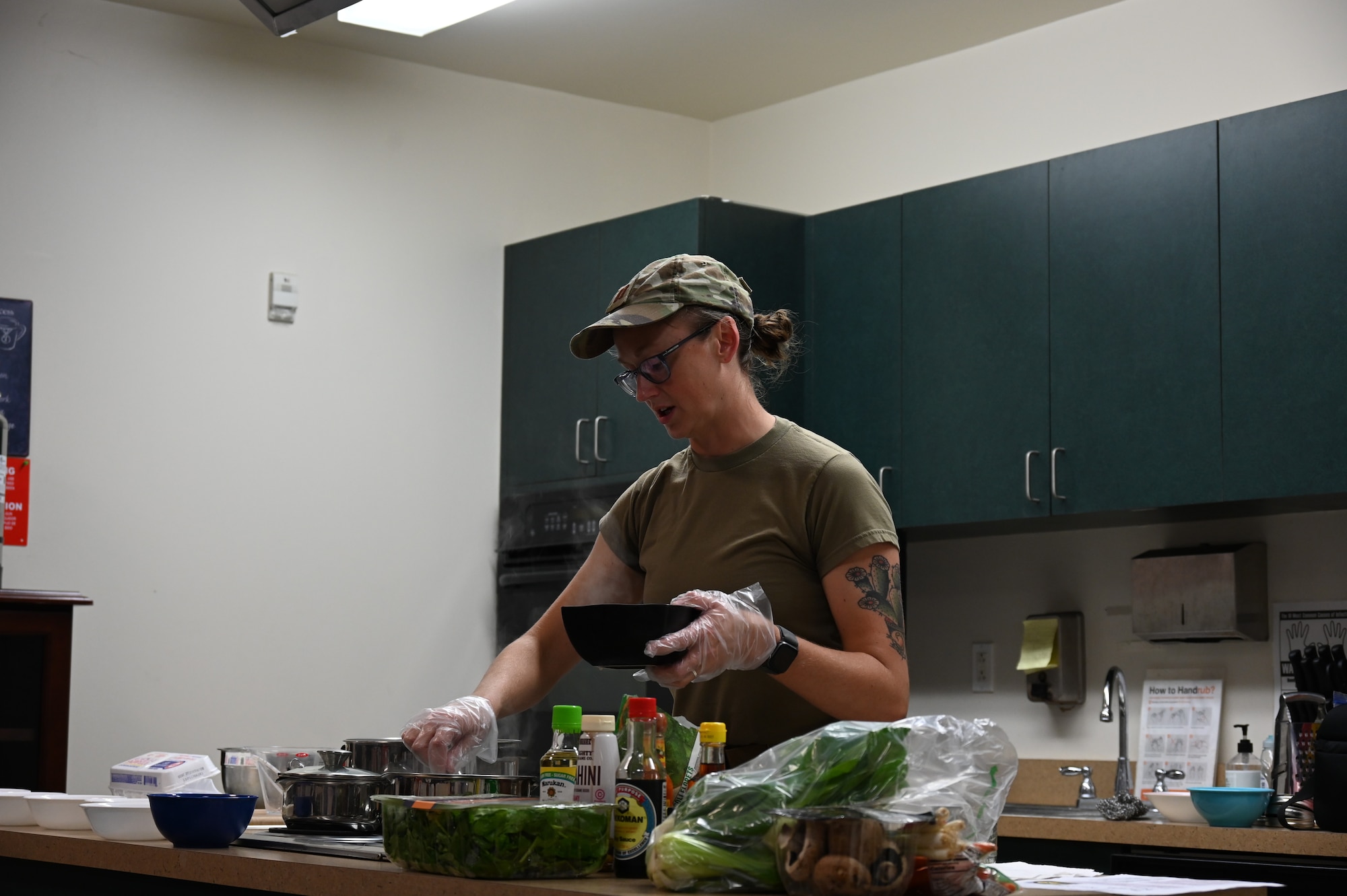 U.S. Air Force Capt. Rebekah Suggs, Laughlin Medical Group operational support team dietitian, adds ramen noodles to a pot of boiling water during the Cooking Connections cooking class at Laughlin Air Force Base, Texas, July 23, 2026. The class focused on creating simple, flavorful meals while teaching practical nutrition and cooking skills that participants can use at home. (U.S. Air Force photo by Airman 1st Class Kylie Rabb)