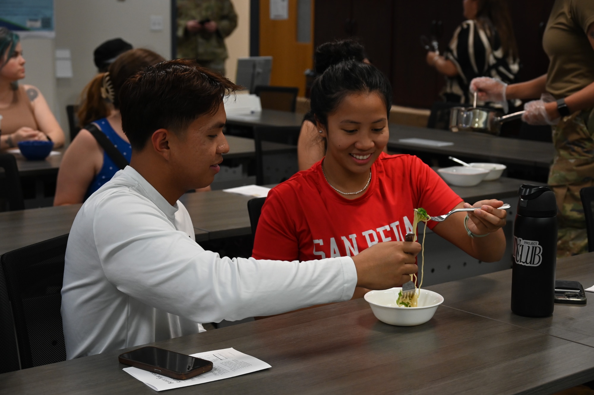 Participants in the Cooking Connections cooking class sample a ramen recipe at Laughlin Air Force Base, Texas, July 23, 2026. Through hands-on instruction, participants explored techniques for preparing nutritious, affordable meals using everyday ingredients. (U.S. Air Force photo by Airman 1st Class Kylie Rabb)