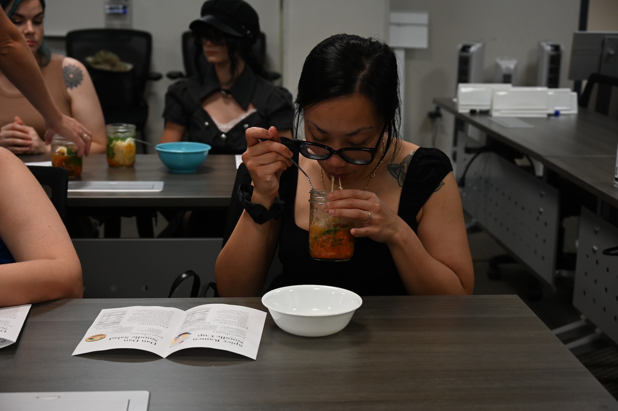 A participant in the Cooking Connections cooking class samples a ramen recipe at Laughlin Air Force Base, Texas, July 23, 2026. The class concluded with a taste test, giving attendees the opportunity to sample the recipes they prepared and discuss the cooking techniques used. (U.S. Air Force photo by Airman 1st Class Kylie Rabb)