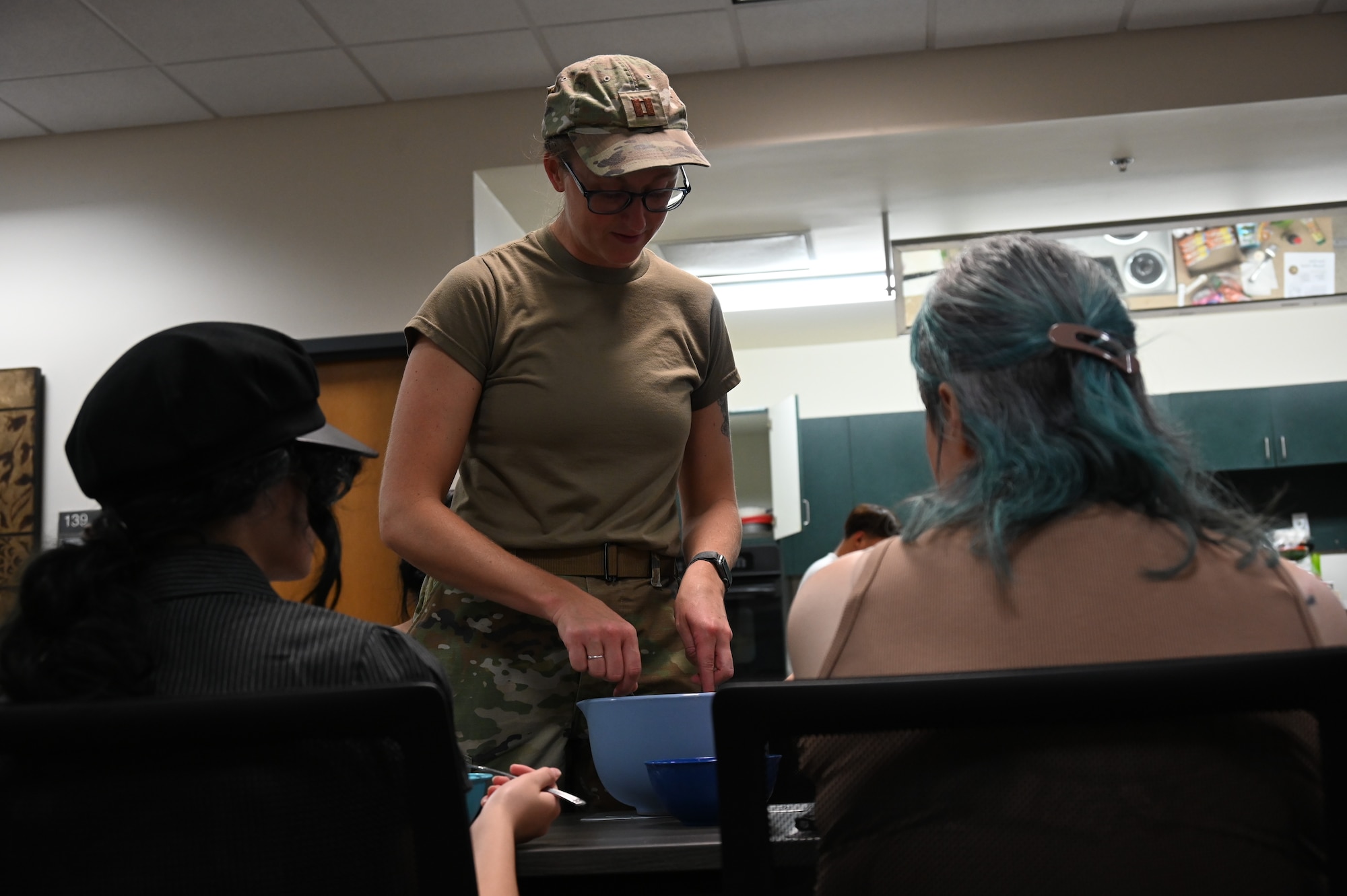 U.S. Air Force Capt. Rebekah Suggs, Laughlin Medical Group operational support team dietitian, serves ramen to participants attending the Cooking Connections cooking class at Laughlin Air Force Base, Texas, July 23, 2026. The interactive class combined nutrition education, hands-on cooking, and a taste test, reinforcing healthy, budget-conscious meal preparation. (U.S. Air Force photo by Airman 1st Class Kylie Rabb)