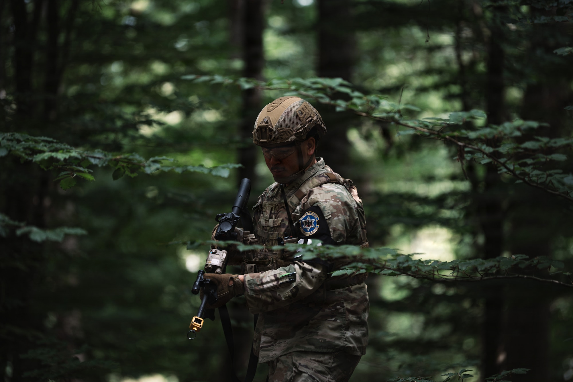 U.S. Air Force Senior Airman Isaac Bell, 569th U.S. Forces Police Squadron patrolman, scouts through the woods during a field training exercise at Kapaun Air Station, Germany, July 23, 2026.