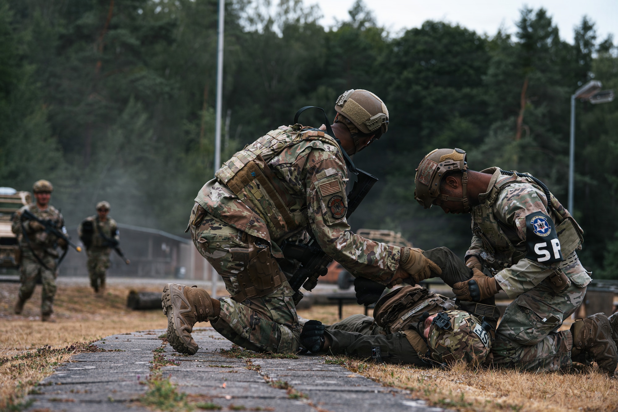 U.S. Air Force Senior Airman Rodney Richburg, 569th U.S. Forces Police Squadron patrolman, right, and Staff Sgt. Caleb Britton, 569th UFPS desk sergeant, perform tactical combat casualty care at Kapaun Air Station, Germany, July 23, 2026.