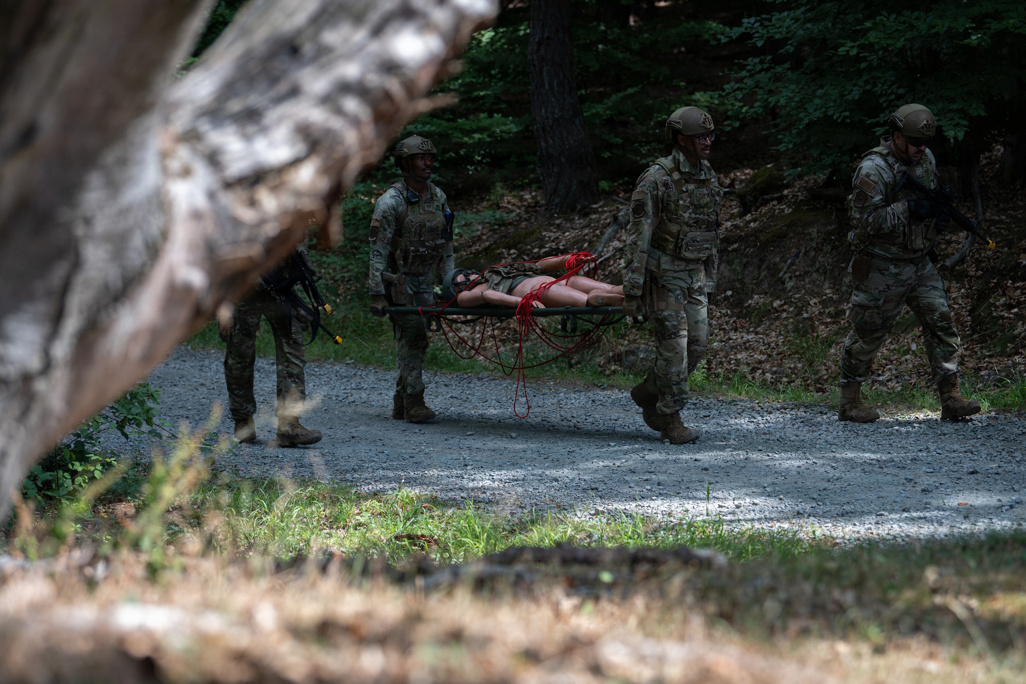 U.S. Air Force Senior Airman Rodney Richburg, 569th U.S. Forces Police Squadron patrolman, back, and Staff Sgt. Caleb Britton, 569th UFPS desk sergeant, carry a mock wounded personnel during a field training exercise at Kapaun Air Station, Germany, July 23, 2026.