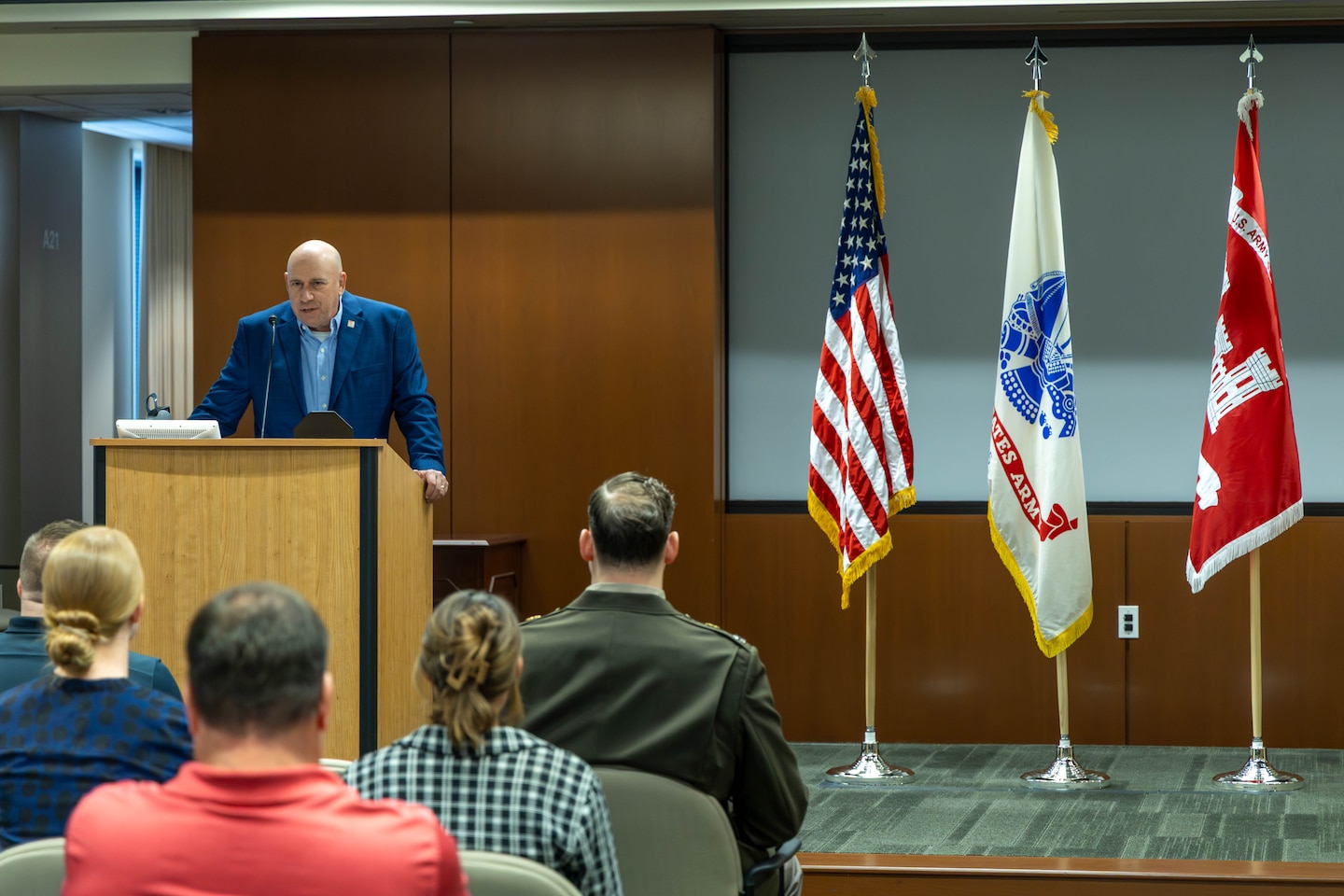 Man at podium during ceremony.