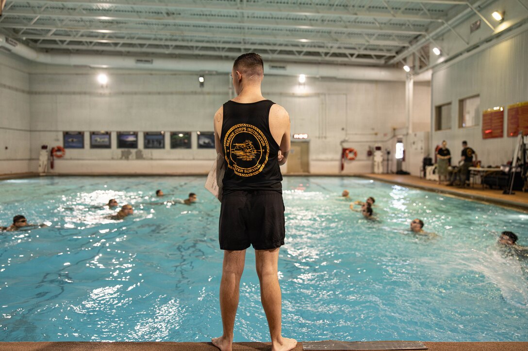 U.S. Marine Corps Sgt. John Davis, a water safety assistant instructor with The Basic School
training command, watches over students performing a water rescue swim during the Water
Survival Advanced Course at Ramer Hall on Marine Corps Base Quantico, Virginia, Jan. 21,
2026. The week-long Water Survival Advanced course challenges Marines’ physical and mental
limits through aquatic endurance training, including long swims, breath holds, and complex
rescue drills vital to amphibious operations. (U.S. Marine Corps photo by Sgt. Dean Gurule)