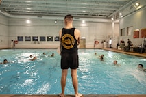 U.S. Marine Corps Sgt. John Davis, a water safety assistant instructor with The Basic School
training command, watches over students performing a water rescue swim during the Water
Survival Advanced Course at Ramer Hall on Marine Corps Base Quantico, Virginia, Jan. 21,
2026. The week-long Water Survival Advanced course challenges Marines’ physical and mental
limits through aquatic endurance training, including long swims, breath holds, and complex
rescue drills vital to amphibious operations. (U.S. Marine Corps photo by Sgt. Dean Gurule)