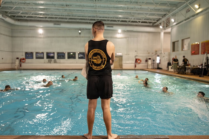 U.S. Marine Corps Sgt. John Davis, a water safety assistant instructor with The Basic School
training command, watches over students performing a water rescue swim during the Water
Survival Advanced Course at Ramer Hall on Marine Corps Base Quantico, Virginia, Jan. 21,
2026. The week-long Water Survival Advanced course challenges Marines’ physical and mental
limits through aquatic endurance training, including long swims, breath holds, and complex
rescue drills vital to amphibious operations. (U.S. Marine Corps photo by Sgt. Dean Gurule)