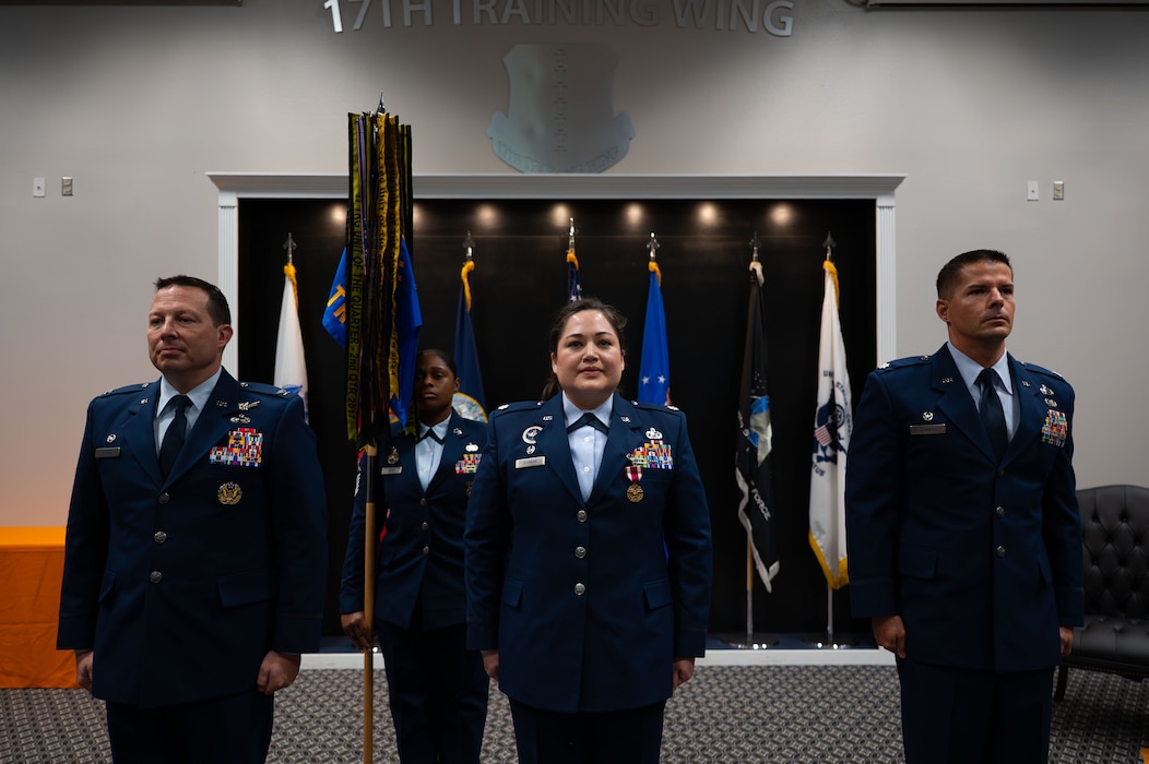 From left to right, U.S. Air Force Col. Jason Gerber, 17th Training Group commander, Lt. Col. Nancy Schwab, outgoing 17th Training Squadron commander, and Lt. Col. Lee Elsenheimer, incoming 17th TRSS commander, prepare for the passing of the guidon during the Change of Command Ceremony, Goodfellow Air Force Base, Texas, July 23, 2026.