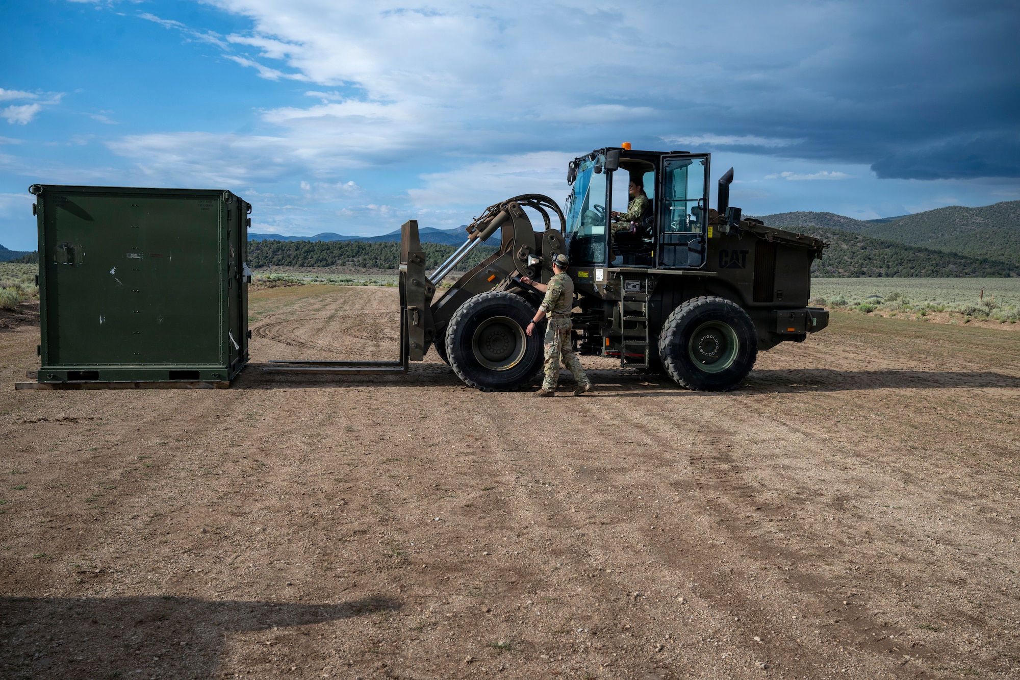 A forklift approaches a container.