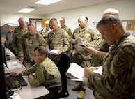 Army Capt. Daniel Zittlow, an Observer Controller Trainer Instructor (OC/T), demonstrates the virtual battle space, to a group of students from class 26-12, July 23, 2026 at Fort McCoy, Wis. Officers from the Danish Home Guard attended class 26-12 as part of the Military Reserve Exchange Program. (U.S. Army Reserve photo by Sgt. 1st Class Justin Hardin)
