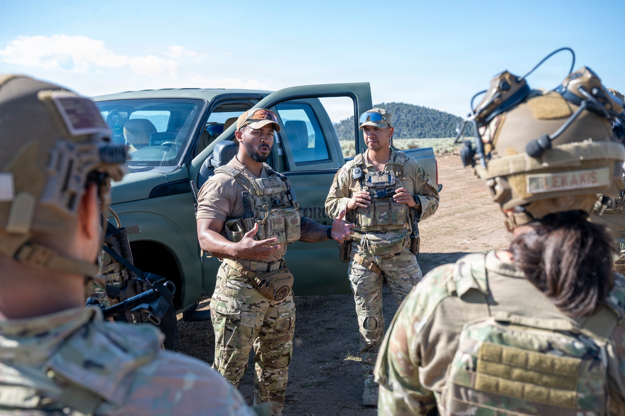 Airmen discuss training in a circle.