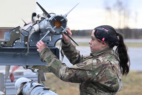 An airman examines a missile.