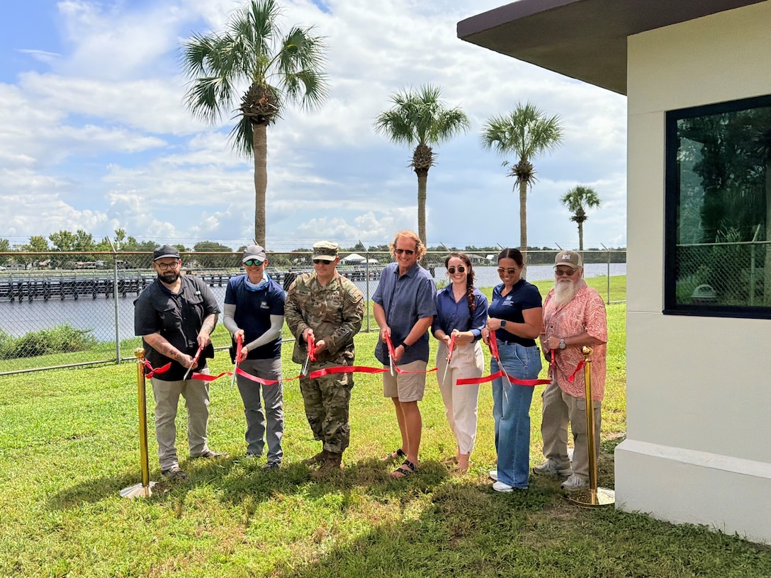District leaders and project team members cut the ceremonial ribbon marking completion of the new lock control building at W.P Franklin Lock and Dam. Pictured left to right: Nathaniel Earnshaw, Project Engineer, Gene Morisani, Chief of Construction Division, Tanner Clark, Chief of Operations Division, Col. Brandon Bowman, Jacksonville District Commander, Nolan Eusebio< West Palm Area Engineer, Lydia Graham, Acting Chief of the South Florida Operations Office, Jeff Fallin, Deputy Chief of Operations Division, and Brandon Burch, Chief of the Multi-Projects Branch. (USACE photo by Peggy Bebb)