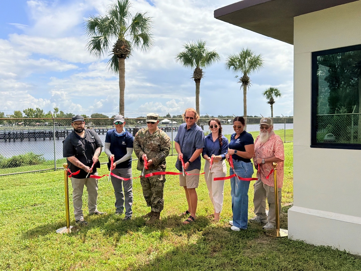 District leaders and project team members cut the ceremonial ribbon marking completion of the new lock control building at W.P Franklin Lock and Dam. Pictured left to right: Nathaniel Earnshaw, Project Engineer, Gene Morisani, Chief of Construction Division, Tanner Clark, Chief of Operations Division, Col. Brandon Bowman, Jacksonville District Commander, Nolan Eusebio< West Palm Area Engineer, Lydia Graham, Acting Chief of the South Florida Operations Office, Jeff Fallin, Deputy Chief of Operations Division, and Brandon Burch, Chief of the Multi-Projects Branch. (USACE photo by Peggy Bebb)