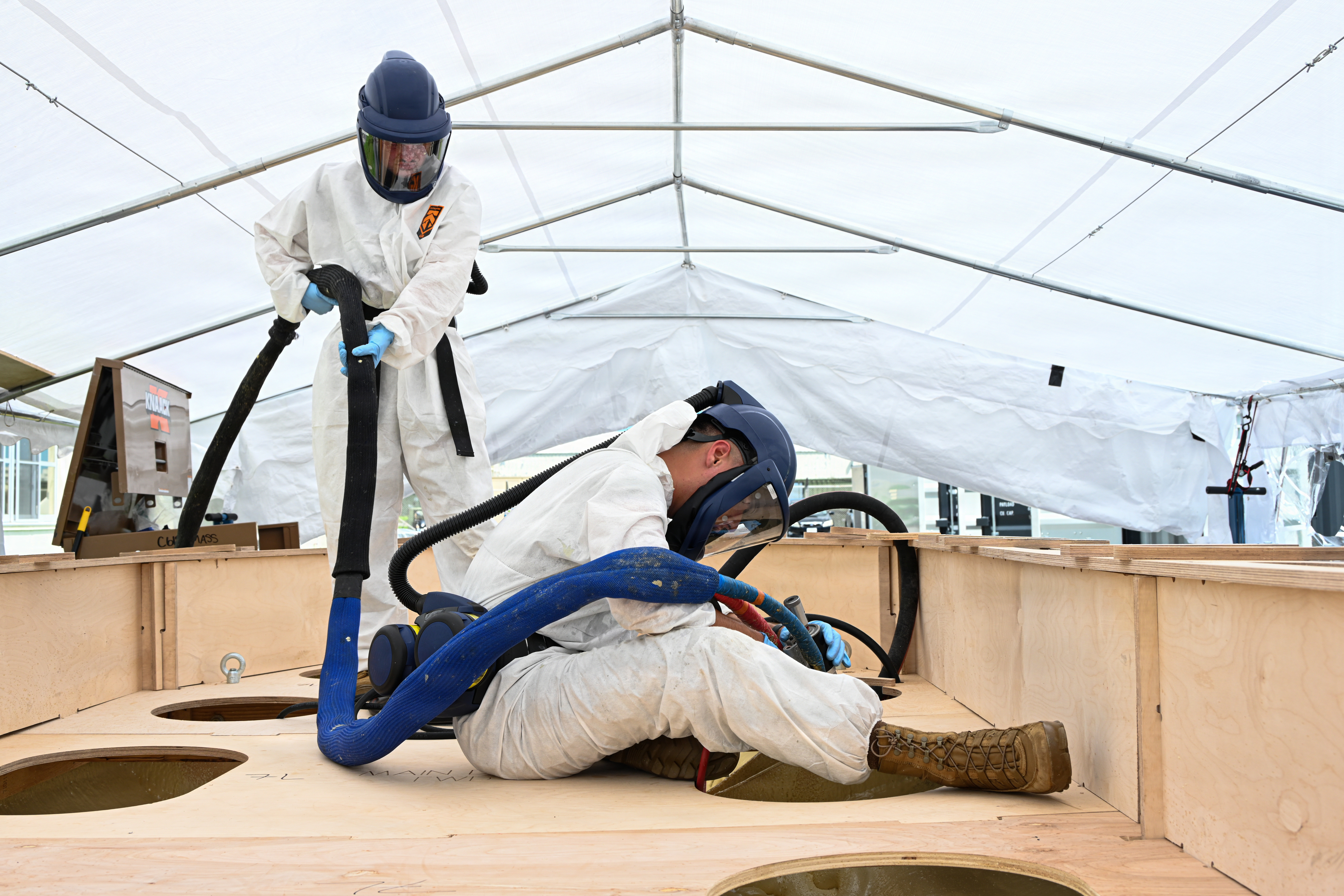U.S. Marine Corps Cpl. Noah Uhrbrock, right, a calibration technician with Intermediate Repair Company, 3rd Maintenance Battalion, 3rd Marine Logistics Group, and Lance Cpl. Joshua Hoover, a welder with 9th Engineer Support Battalion, Combat Logistics Regiment 37, 3rd MLG, spray internal foam into a Foam Raiding Caft mold during Valiant Shield 26 on Camp Kinser, Okinawa, Japan, June 22, 2026. IRC Marines participated in Resilient Advanced Manufacturing for Contested Environments, or RAMFORCE, an initiative hosted by the Office of the Under Secretary of Defense for Research and Engineering. The innovative event brought together military personnel, government laboratories, and private industry to evaluate how advanced manufacturing technologies could enable expeditionary forces to repair, replace and even produce critical equipment at the point of need. (U.S. Marine Corps photo by Cpl. Rachel Mason)