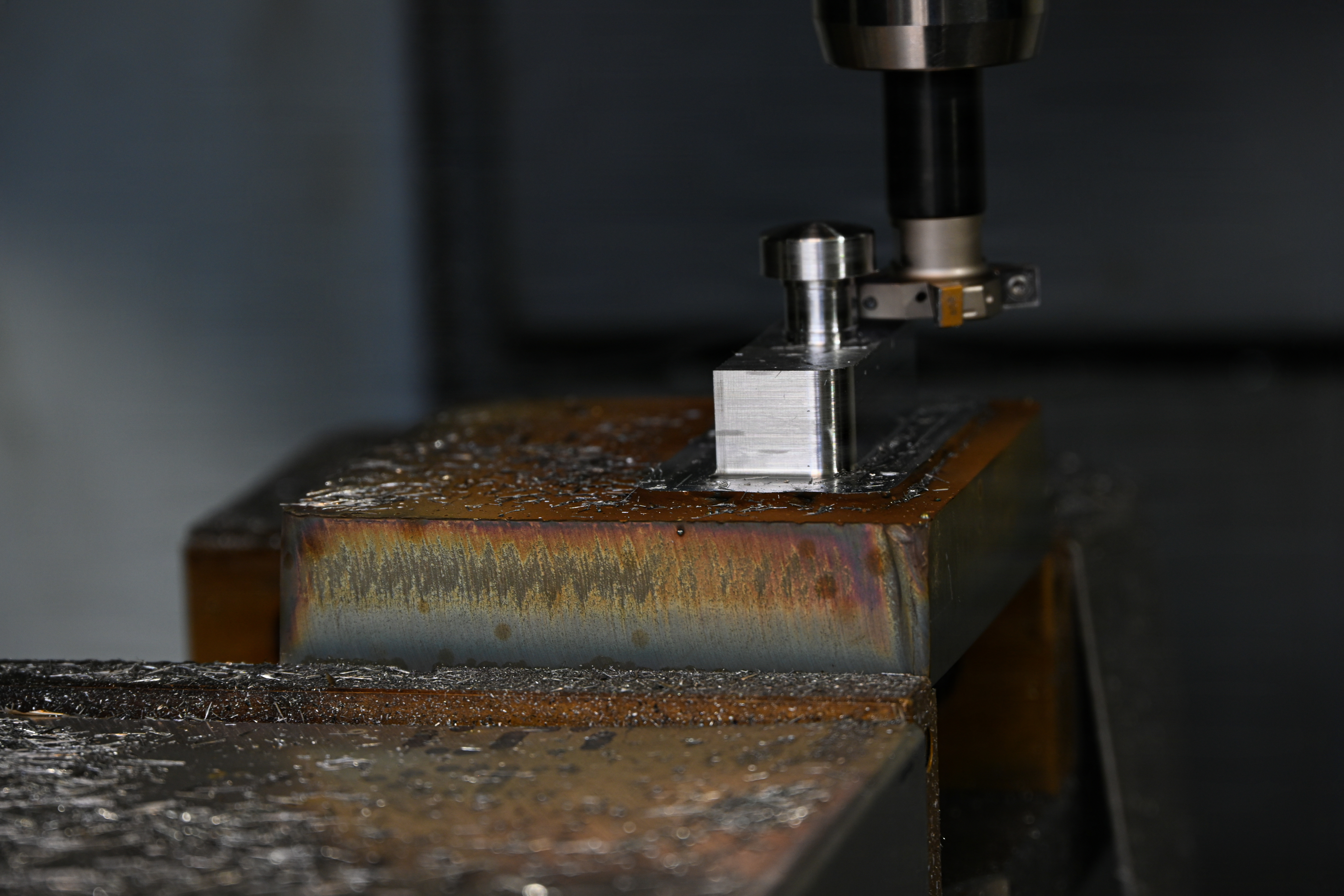 An additive hybrid machine prints on an additive stainless-steel block using a welder during Valiant Shield 26 on Camp Kinser, Okinawa, Japan, June 23, 2026. Marines with Intermediate Repair Company, 3rd Maintenance Battalion, 3rd Marine Logistics Group, participated in Resilient Advanced Manufacturing for Contested Environments, or RAMFORCE, an initiative hosted by the Office of the Under Secretary of Defense for Research and Engineering. The innovative event brought together military personnel, government laboratories, and private industry to evaluate how advanced manufacturing technologies could enable expeditionary forces to repair, replace and even produce critical equipment at the point of need. (U.S. Marine Corps photo by Cpl. Rachel Mason)