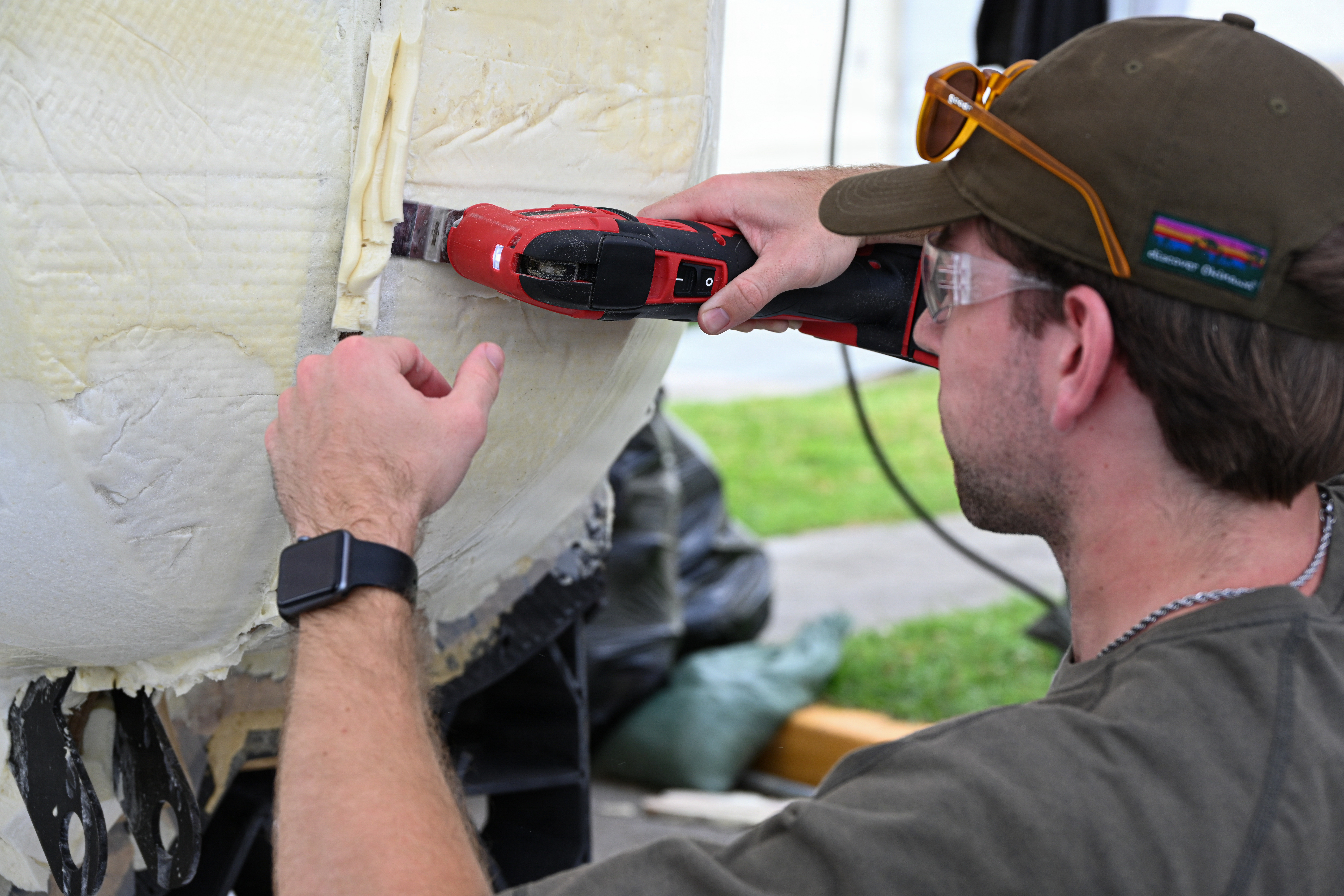 Ryan Smith, a Department of Navy civilian with Naval Surface Warfare Center Carderock, uses a multitool to remove excess foam from a Foam Raiding Craft during Valiant Shield 26 on Camp Kinser, Okinawa, Japan, June 23, 2026. Marines with Intermediate Repair Company, 3rd Maintenance Battalion, 3rd Marine Logistics Group, participated in Resilient Advanced Manufacturing for Contested Environments, or RAMFORCE, an initiative hosted by the Office of the Under Secretary of Defense for Research and Engineering. The innovative event brought together military personnel, government laboratories, and private industry to evaluate how advanced manufacturing technologies could enable expeditionary forces to repair, replace and even produce critical equipment at the point of need. (U.S. Marine Corps photo by Cpl. Rachel Mason)