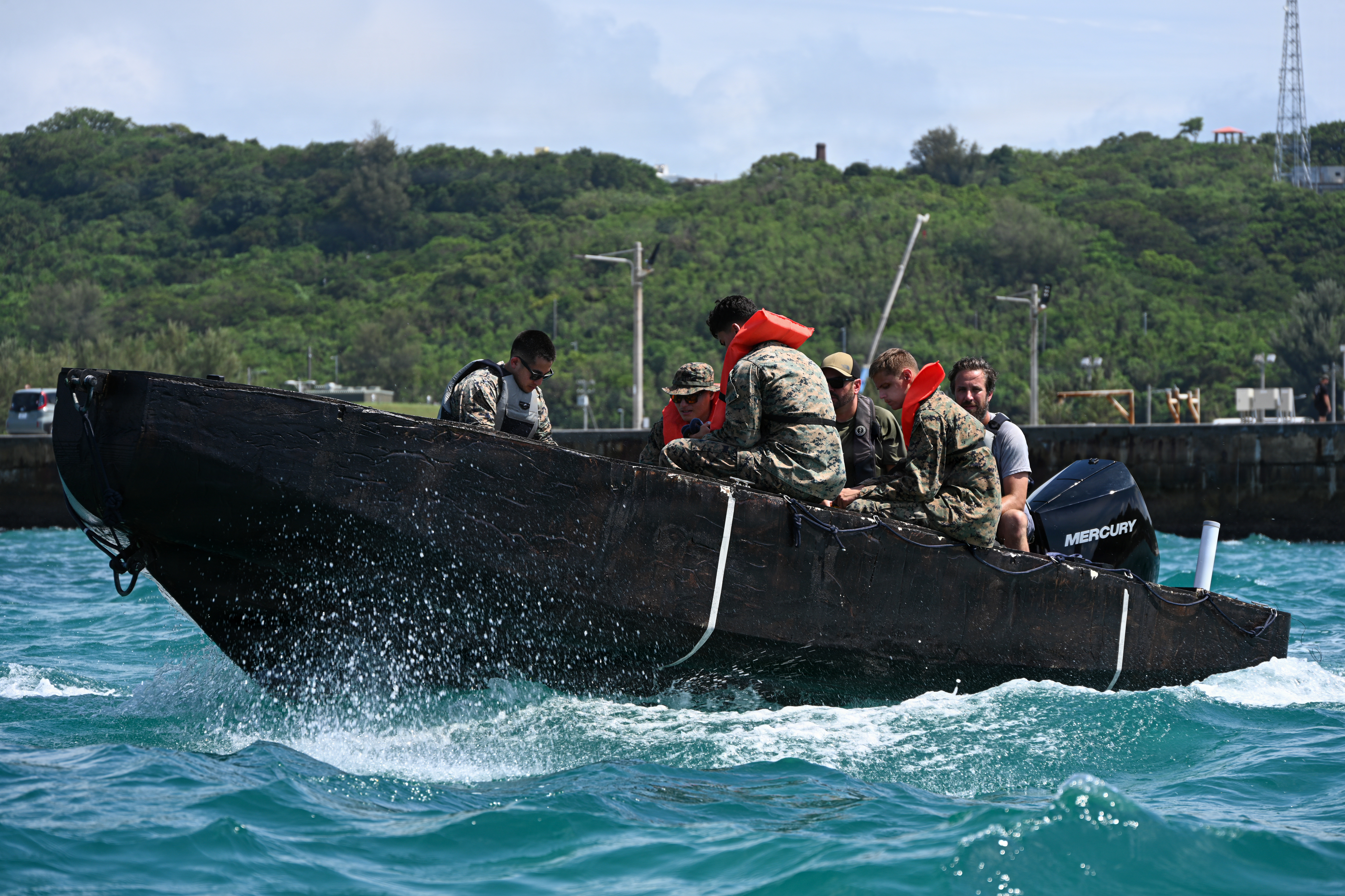 U.S. Marines with Intermediate Repair Company, 3rd Maintenance Battalion, 3rd Marine Logistics Group, and Department of Navy civilians from Naval Surface Warfare Center Carderock, ride in a remote-control Foam Raiding Craft during Valiant Shield 26 at White Beach, Okinawa, Japan, June 29, 2026. The foam craft was created in part by Marines with IRC as part of Resilient Advanced Manufacturing for Contested Environments, or RAMFORCE, an initiative hosted by the Office of the Under Secretary of Defense for Research and Engineering. The innovative event brought together military personnel, government laboratories, and private industry to evaluate how advanced manufacturing technologies could enable expeditionary forces to repair, replace and even produce critical equipment at the point of need. (U.S. Marine Corps photo by Cpl. Rachel Mason)