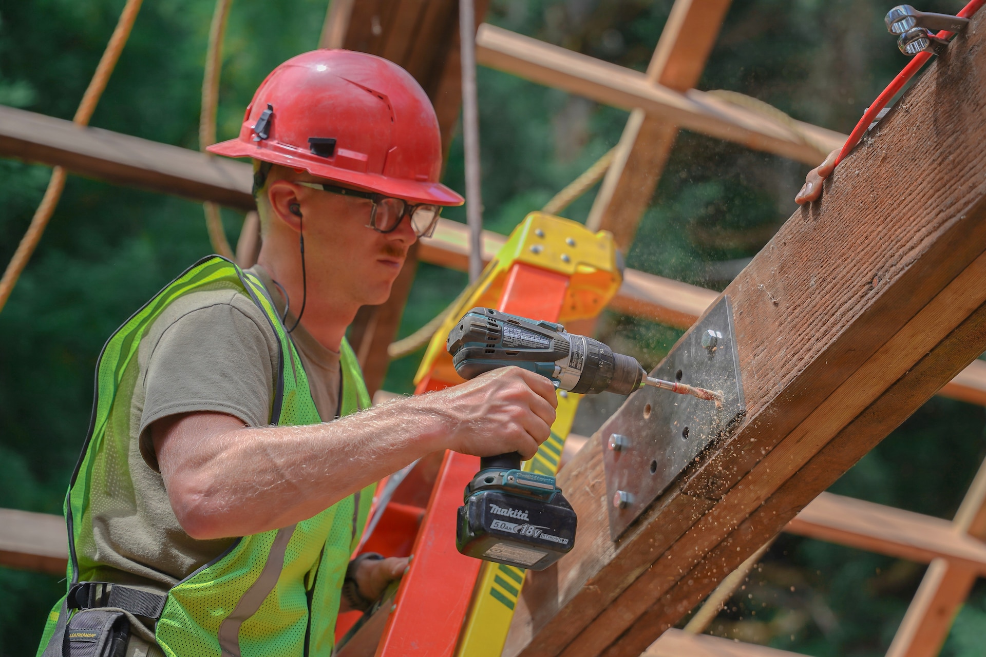 U.S. Air Force Senior Master Sgt. Daniel Hart, the structures senior noncommissioned officer in charge of the 201st Rapid Engineer Deployable Heavy Operational Repair Squadron Engineers, Pennsylvania Air National Guard project, installs reinforcement plates on roof trusses at Redwood National and State Parks near Orick, California, July 14, 2026. Hart’s work reinforced connections in the aging roof frame and prepared it for new sheathing and metal panels. (U.S. Air National Guard photo by Airman 1st Class Austin Stern)