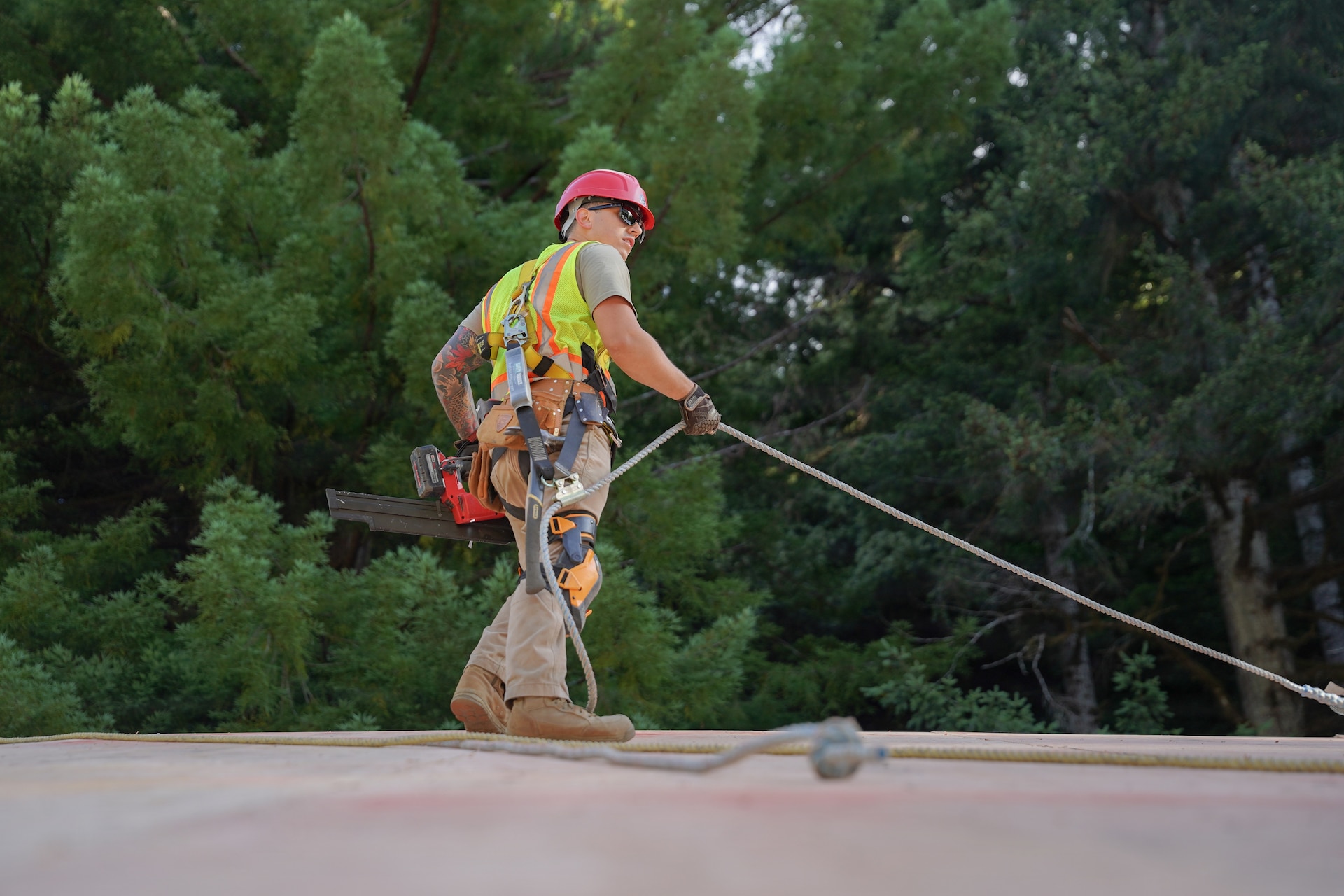 U.S. Air Force Tech. Sgt. Caleb Yinger, a structures craftsman assigned to the 201st Rapid Engineer Deployable Heavy Operational Repair Squadron Engineers, Pennsylvania Air National Guard, installs plywood roof sheathing at Redwood National and State Parks near Orick, California, July 16, 2026. The sheathing created a continuous surface for the weather-resistant roofing system that followed. (U.S. Air National Guard photo by Airman 1st Class Austin Stern)