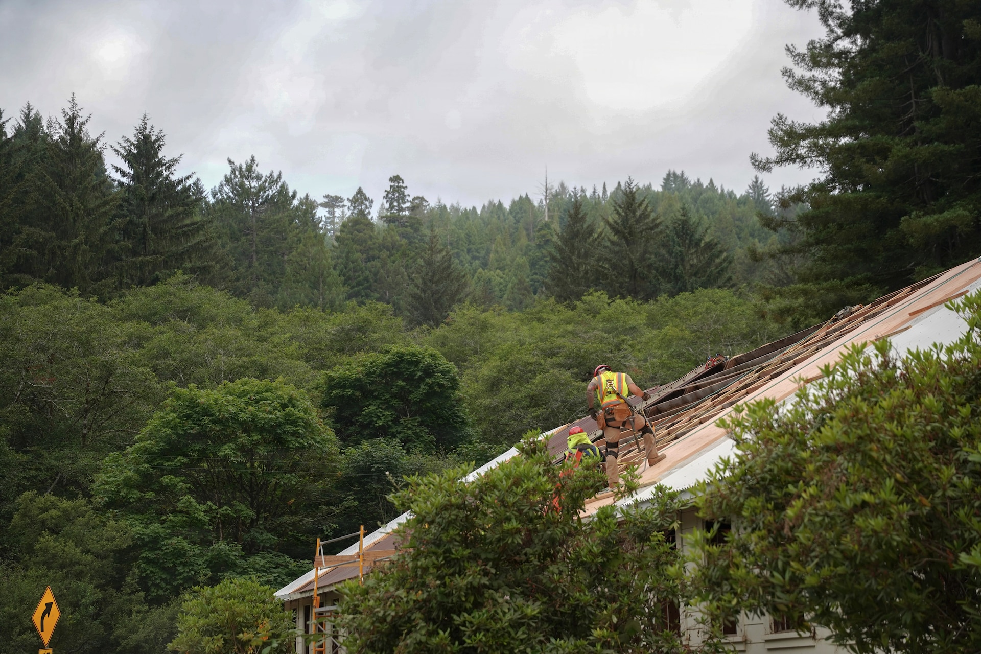 U.S. Air Force Airmen assigned to the 201st Rapid Engineer Deployable Heavy Operational Repair Squadron Engineers, Pennsylvania Air National Guard, secure roofing panels at Redwood National and State Parks near Orick, California, July 17, 2026. The panels form a durable weather barrier over the repaired roof structure. (U.S. Air National Guard photo by Airman 1st Class Austin Stern)