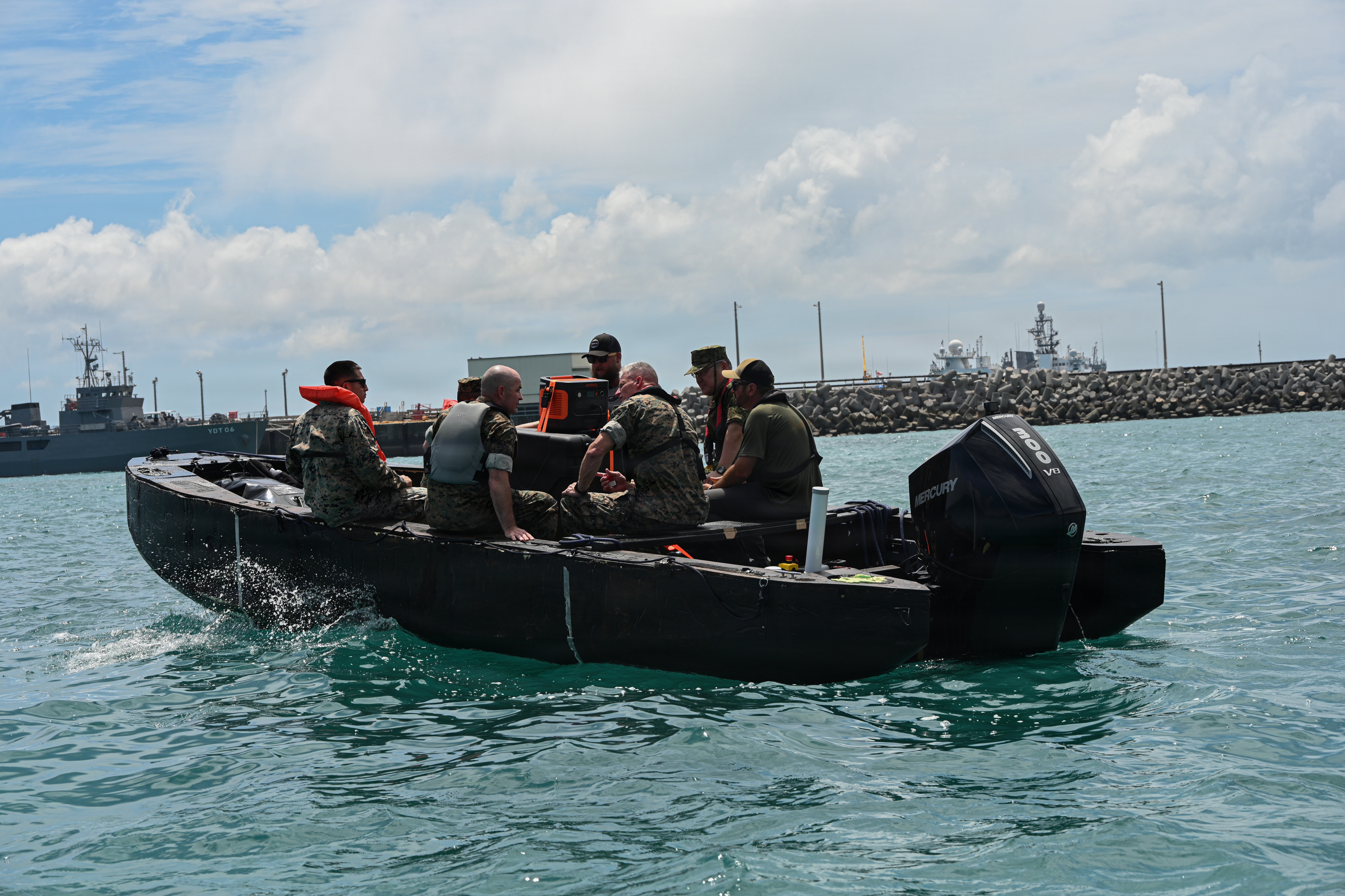 Japan Ground Self-Defense Force Lt. Gen. Seiji Toriumi, second from right, commanding general of Western Army, and U.S. Marine Corps Lt. Gen. Roger Turner, third from right, Commanding General of III Marine Expeditionary Force, and others ride on a Foam Raiding Craft during Valiant Shield 26 at White Beach, Okinawa, Japan, June 29, 2026. The foam craft was created in part by Marines with Intermediate Repair Company, 3rd Maintenance Battalion, 3rd Marine Logistics Group, as part of Resilient Advanced Manufacturing for Contested Environments, or RAMFORCE, an initiative hosted by the Office of the Under Secretary of Defense for Research and Engineering. The innovative event brought together military personnel, government laboratories, and private industry to evaluate how advanced manufacturing technologies could enable expeditionary forces to repair, replace and even produce critical equipment at the point of need. (U.S. Marine Corps photo by Cpl. Rachel Mason)