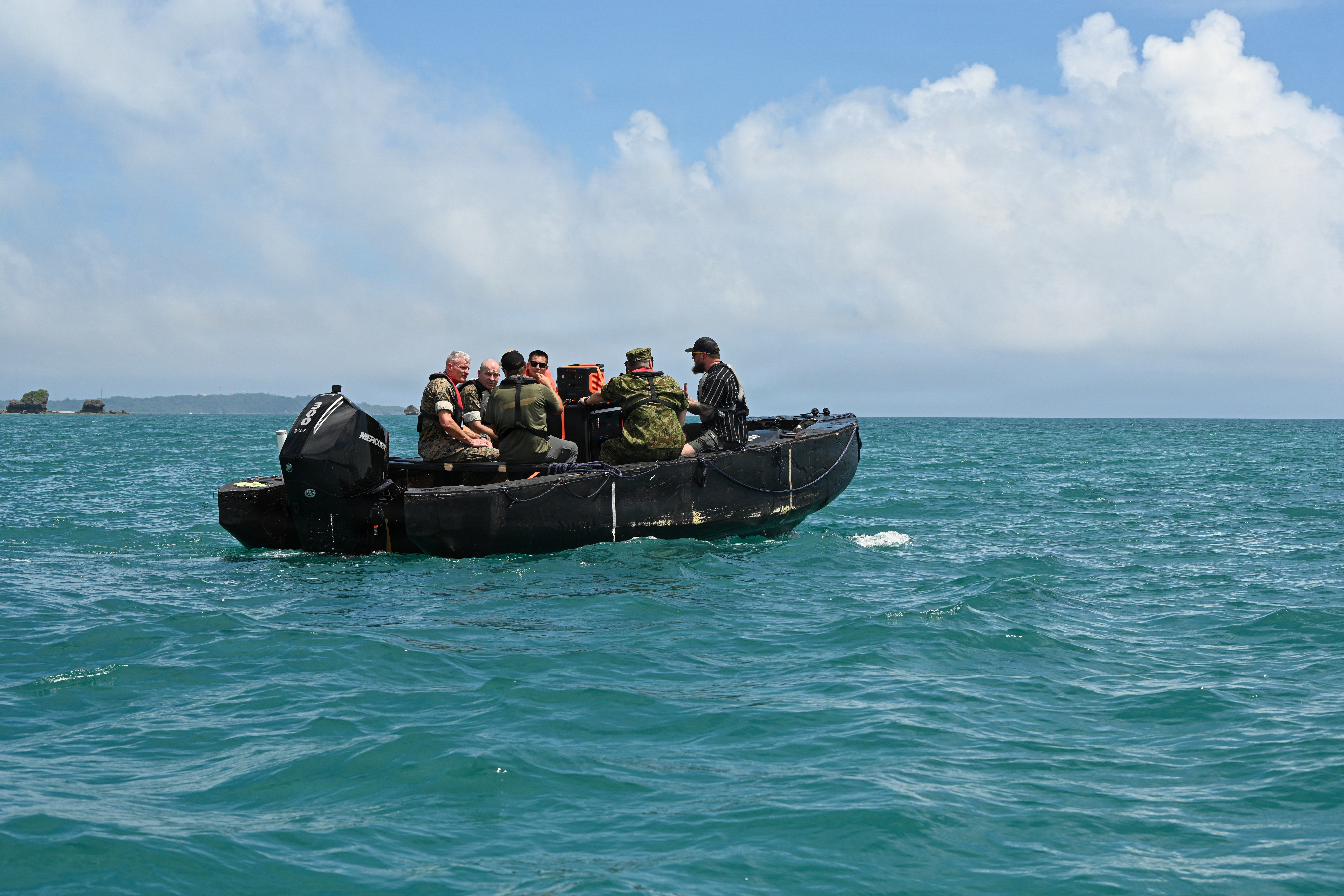 Japan Ground Self-Defense Force Lt. Gen. Seiji Toriumi, second from right, commanding general of Western Army, and U.S. Marine Corps Lt. Gen. Roger Turner, third from right, Commanding General of III Marine Expeditionary Force, and others ride on a Foam Raiding Craft during Valiant Shield 26 at White Beach, Okinawa, Japan, June 29, 2026. The foam craft was created in part by Marines with Intermediate Repair Company, 3rd Maintenance Battalion, 3rd Marine Logistics Group, as part of Resilient Advanced Manufacturing for Contested Environments, or RAMFORCE, an initiative hosted by the Office of the Under Secretary of Defense for Research and Engineering. The innovative event brought together military personnel, government laboratories, and private industry to evaluate how advanced manufacturing technologies could enable expeditionary forces to repair, replace and even produce critical equipment at the point of need. (U.S. Marine Corps photo by Cpl. Rachel Mason)