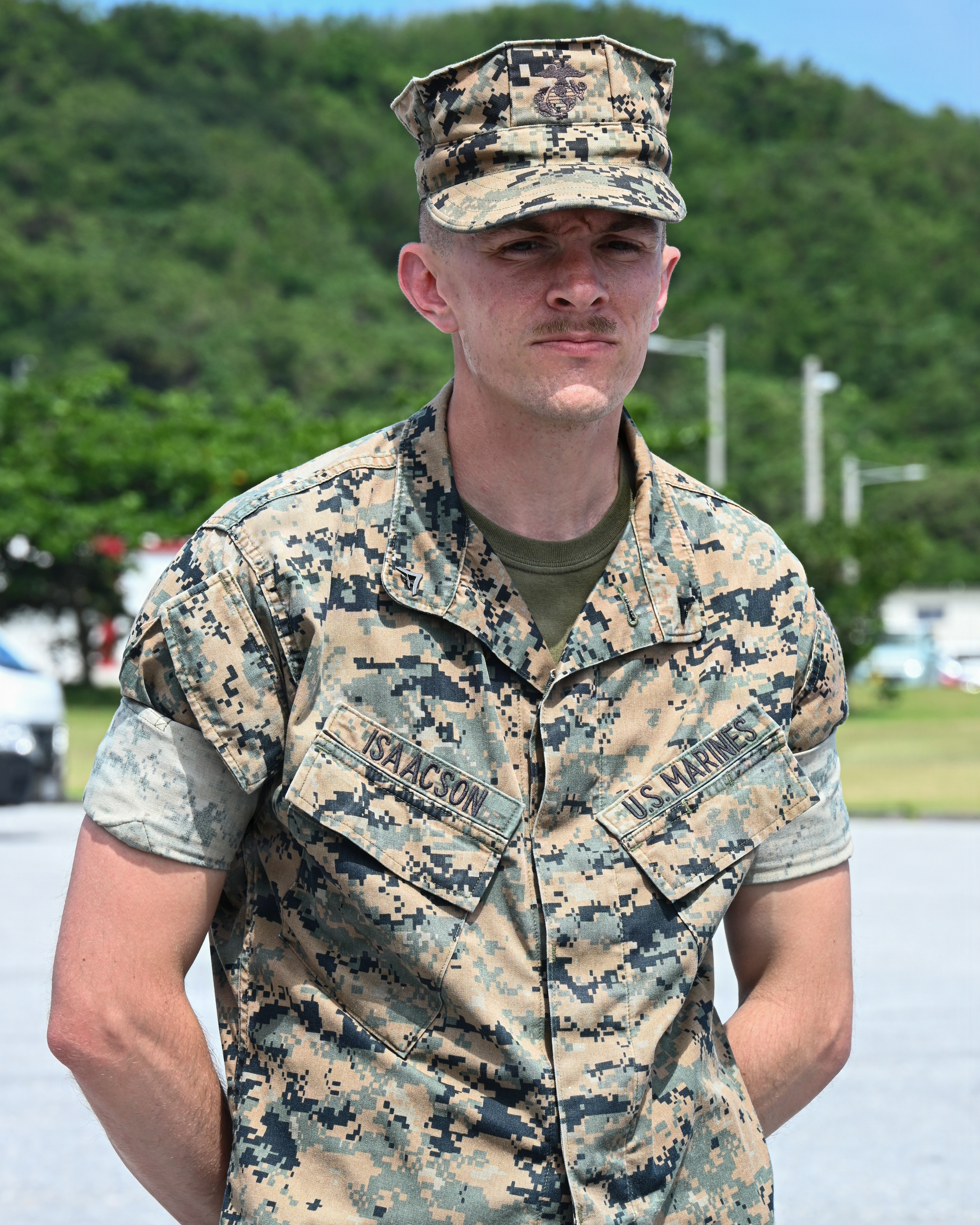 U.S. Marine Corps Lance Cpl. Blake Isaacson, a utilities systems technician with Intermediate Repair Company, 3rd Maintenance Battalion, 3rd Marine Logistics Group, stands at parade rest before being presented with a coin during Valiant Shield 26 at White Beach, Okinawa, Japan, June 29, 2026. Intermediate Repair Company participated in Resilient Advanced Manufacturing for Contested Environments, or RAMFORCE, an initiative hosted by the Office of the Under Secretary of Defense for Research and Engineering. The innovative event brought together military personnel, government laboratories and private industry to evaluate how advanced manufacturing technologies could enable expeditionary forces to repair, replace and even produce critical equipment at the point of need. (U.S. Marine Corps photo by Cpl. Rachel Mason)
