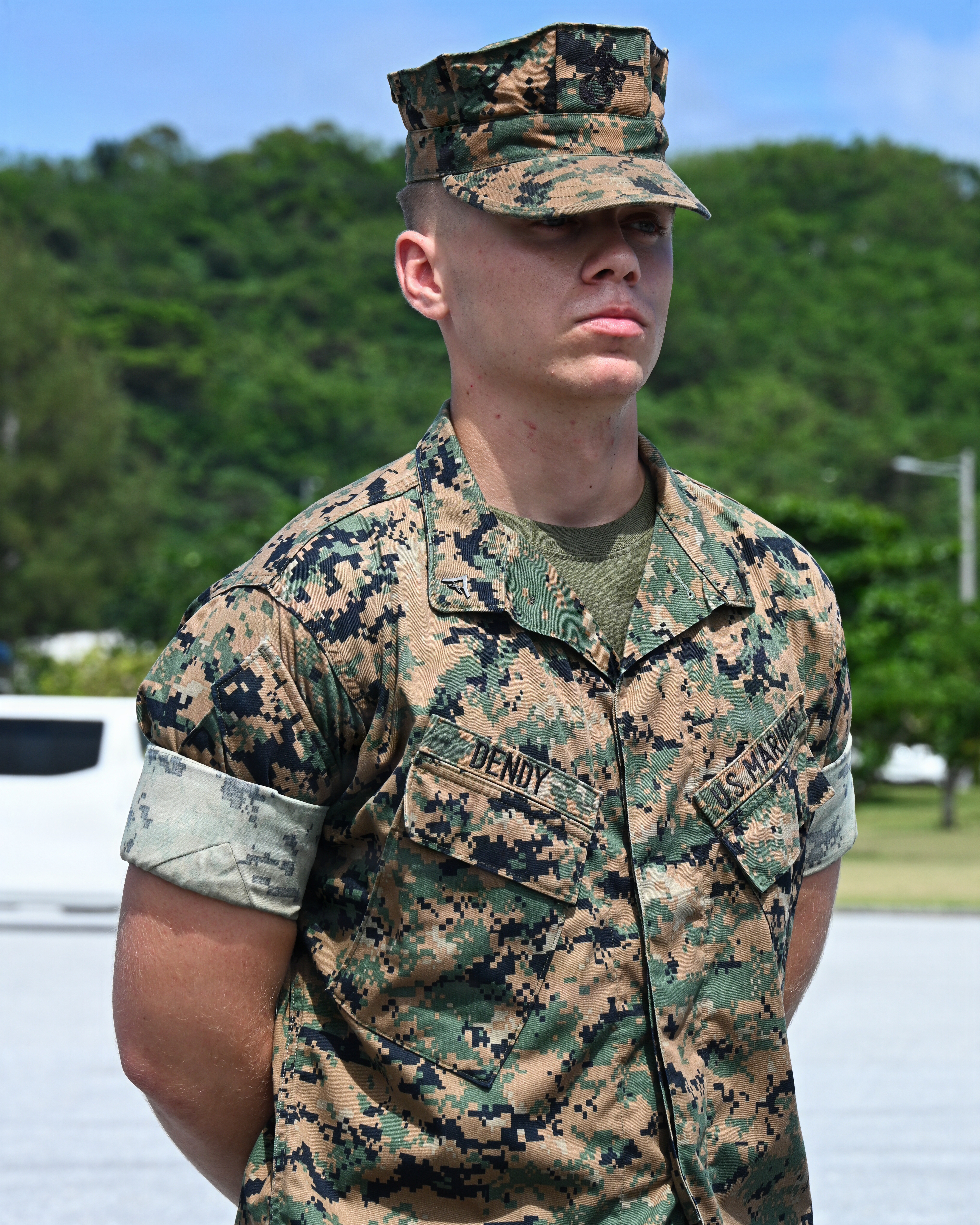 U.S. Marine Corps Lance Cpl. Jesse Dendy, an amphibious combat vehicle technician with Intermediate Repair Company, 3rd Maintenance Battalion, 3rd Marine Logistics Group, stands at parade rest before receiving a Navy and Marine Corps Achievement Medal during Valiant Shield 26 at White Beach, Okinawa, Japan, June 29, 2026. Intermediate Repair Company participated in Resilient Advanced Manufacturing for Contested Environments, or RAMFORCE, an initiative hosted by the Office of the Under Secretary of Defense for Research and Engineering. The innovative event brought together military personnel, government laboratories and private industry to evaluate how advanced manufacturing technologies could enable expeditionary forces to repair, replace and even produce critical equipment at the point of need. (U.S. Marine Corps photo by Cpl. Rachel Mason)