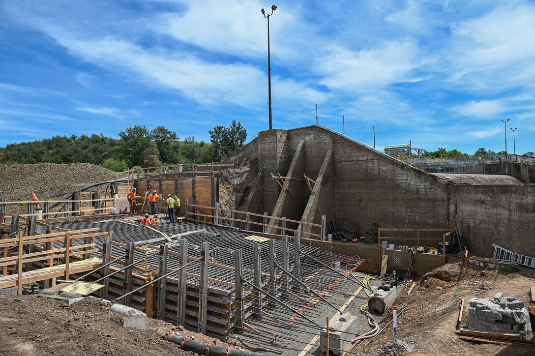 Newly constructed concrete retaining walls at the Mill Creek Fish Ladder Project, a project designed to improve fish passage and manage water flows.