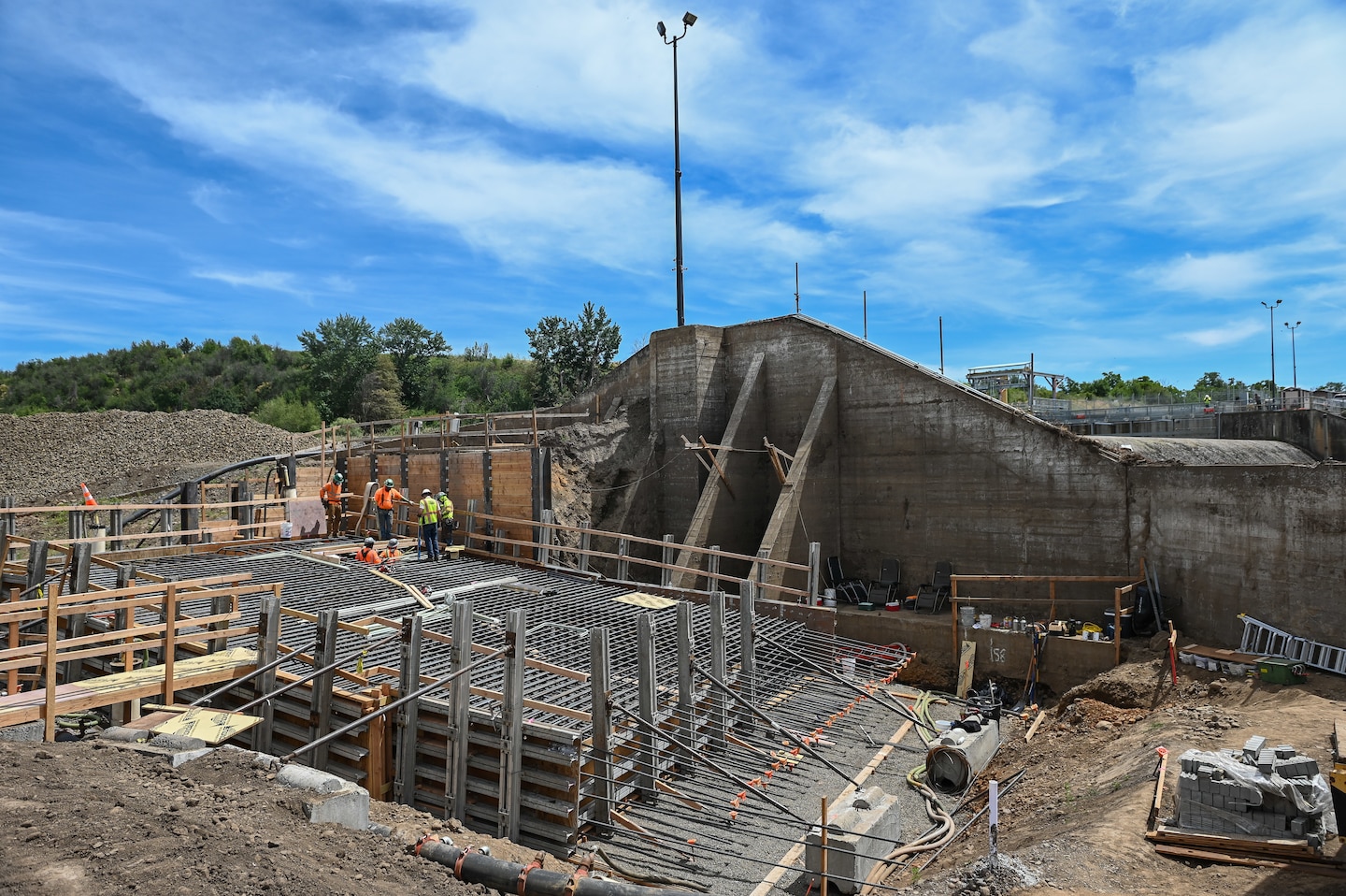 Newly constructed concrete retaining walls at the Mill Creek Fish Ladder Project, a project designed to improve fish passage and manage water flows.